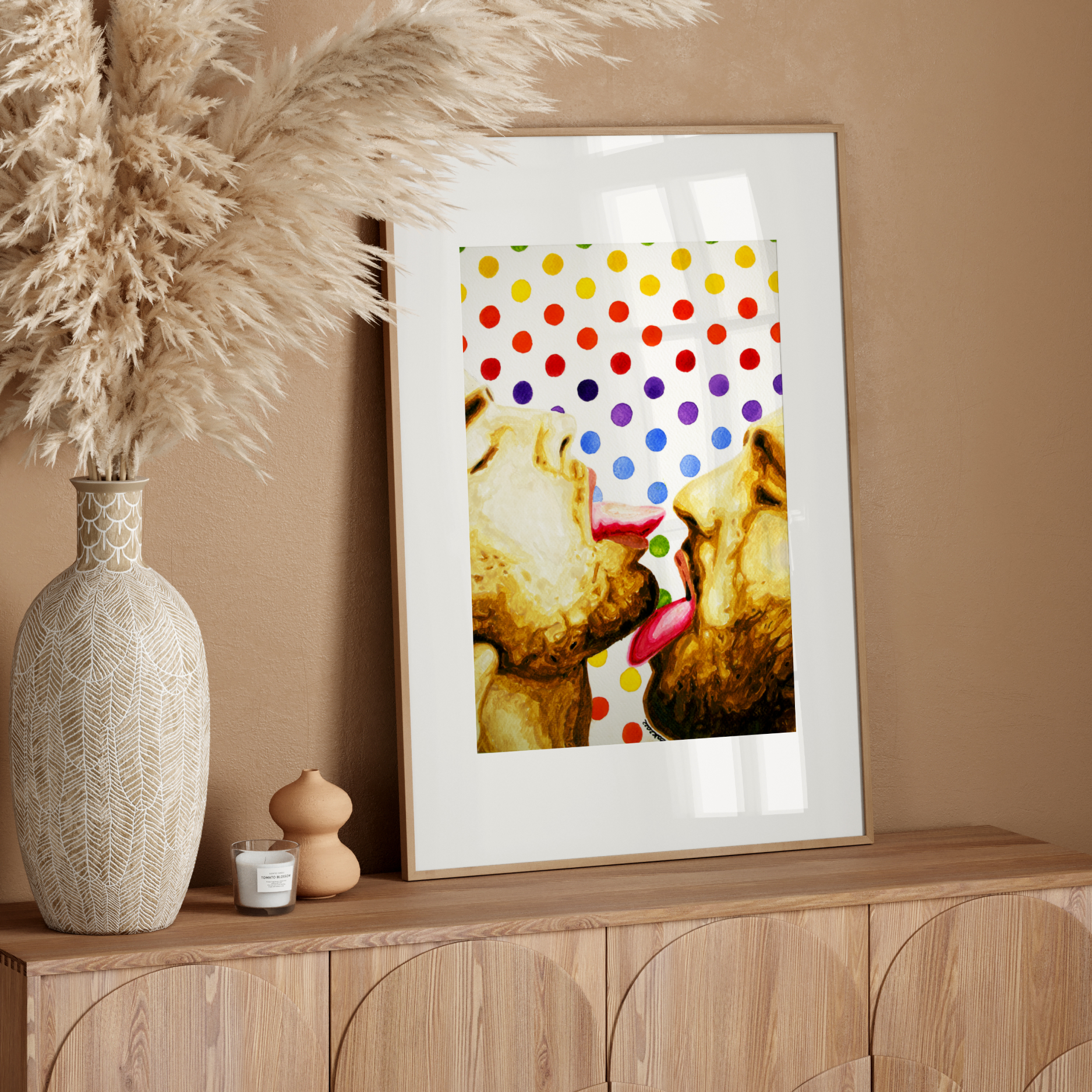 Framed artwork of two gay couple kissing with a colorful polka dot background.