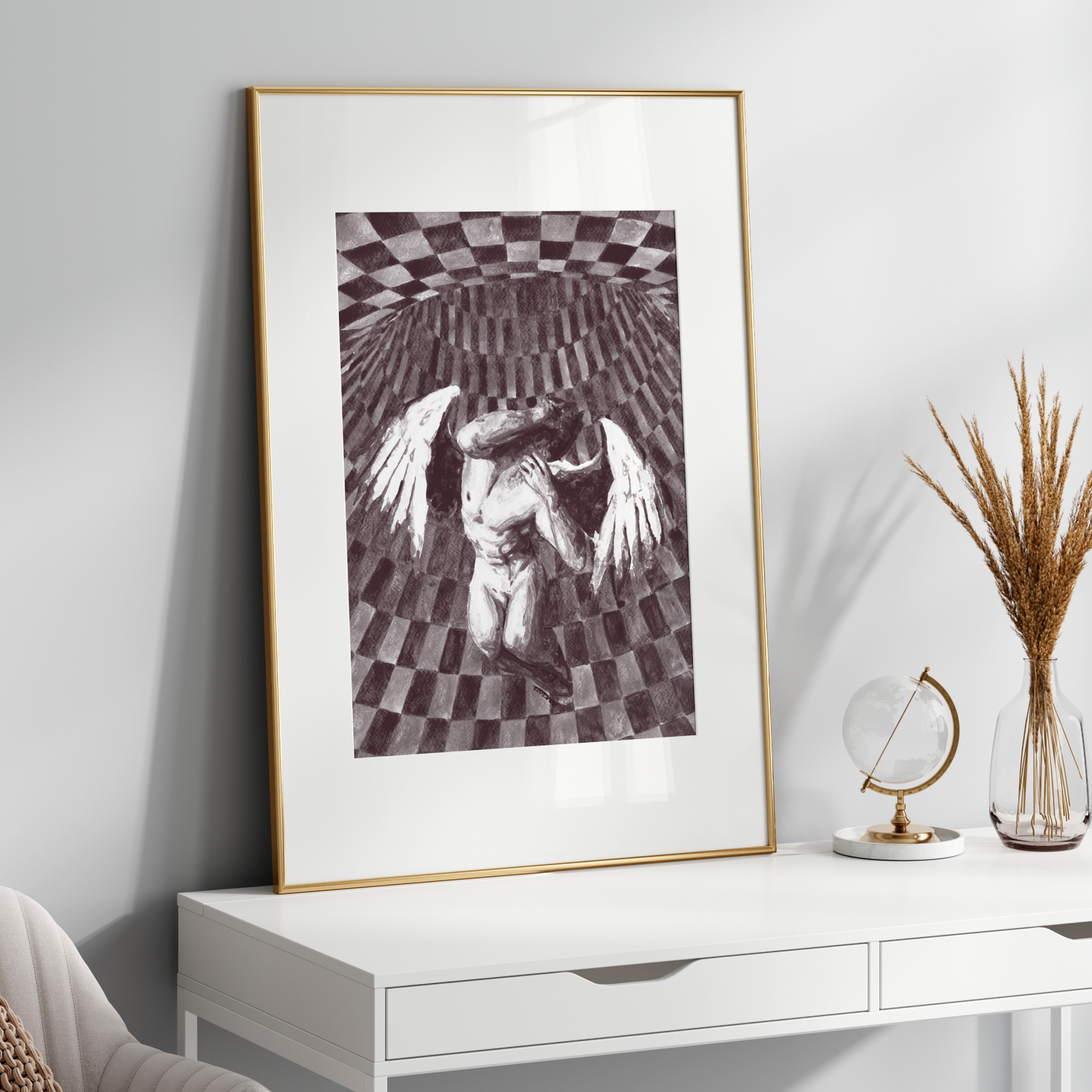 Framed artwork on a white wall above a white console table with decorative items.