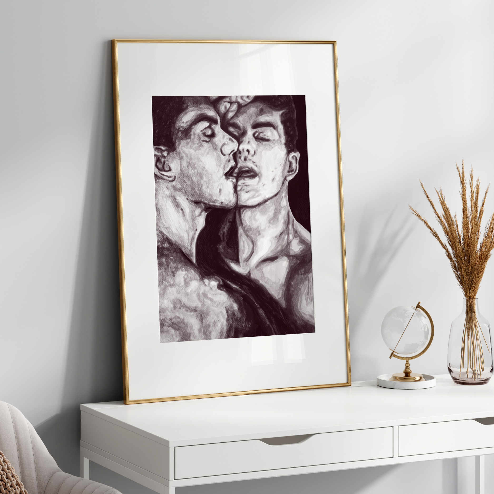 Framed black and white artwork on a white wall above a white console table.