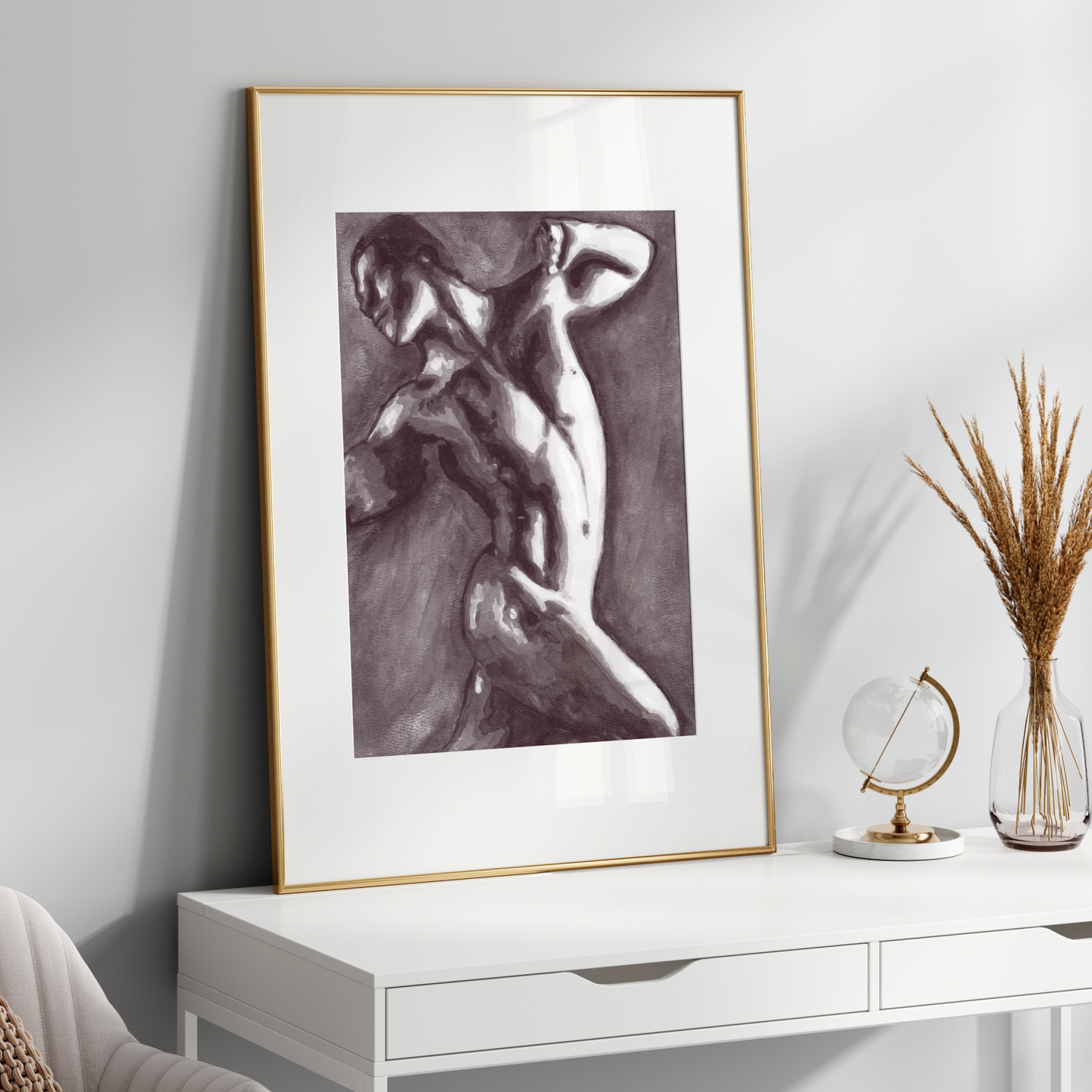 Framed black and white artwork on a white wall above a white console table with decorative items.