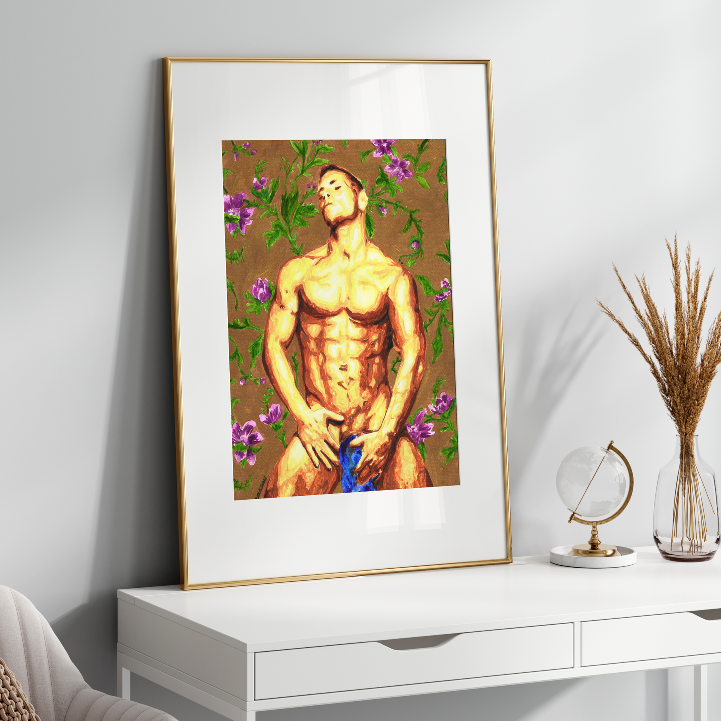 Framed artwork of a muscular figure with flowers on a white wall above a white console table.