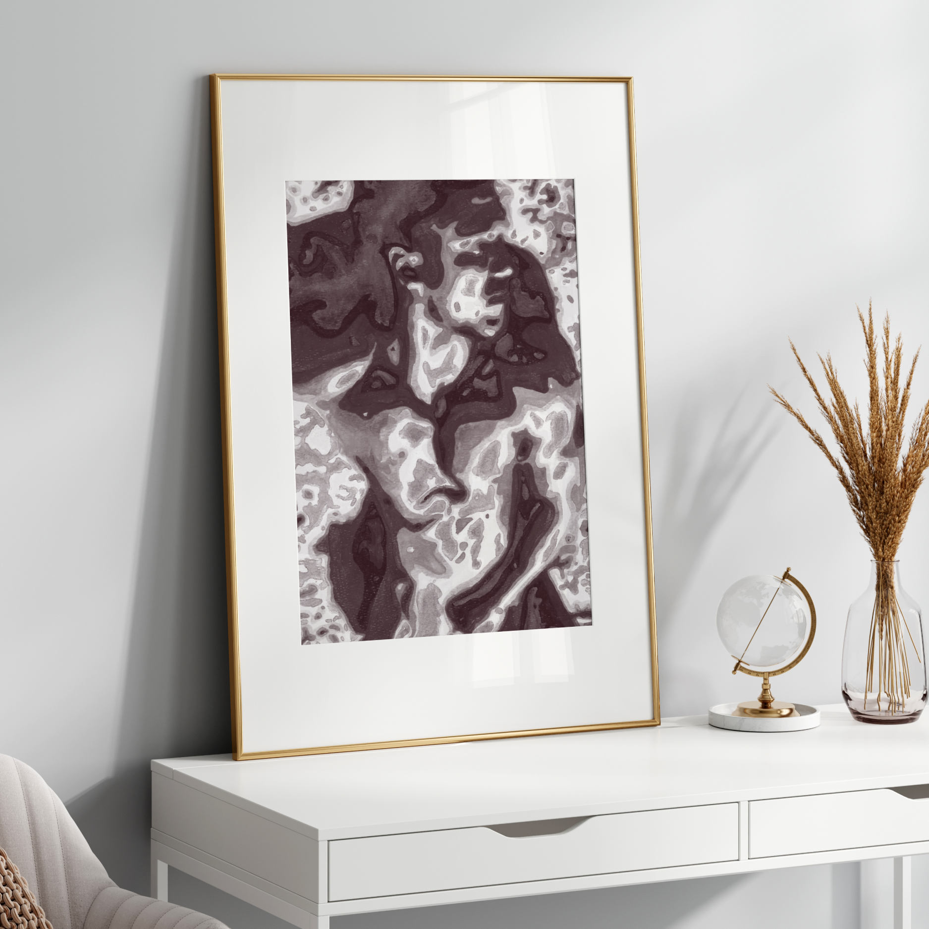 Framed abstract art on a white wall above a white console table with decorative items.