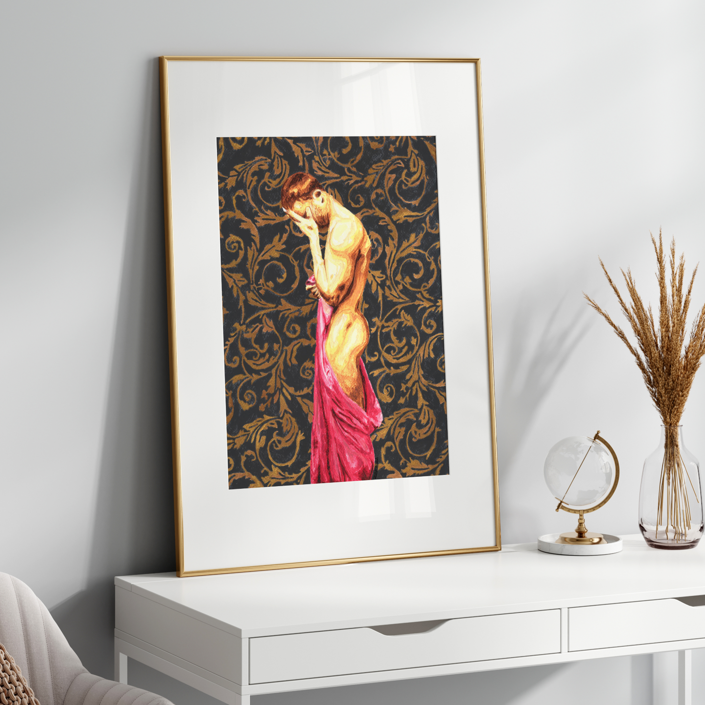 Framed artwork of a nude figure with a decorative pattern on a white wall above a white console table.