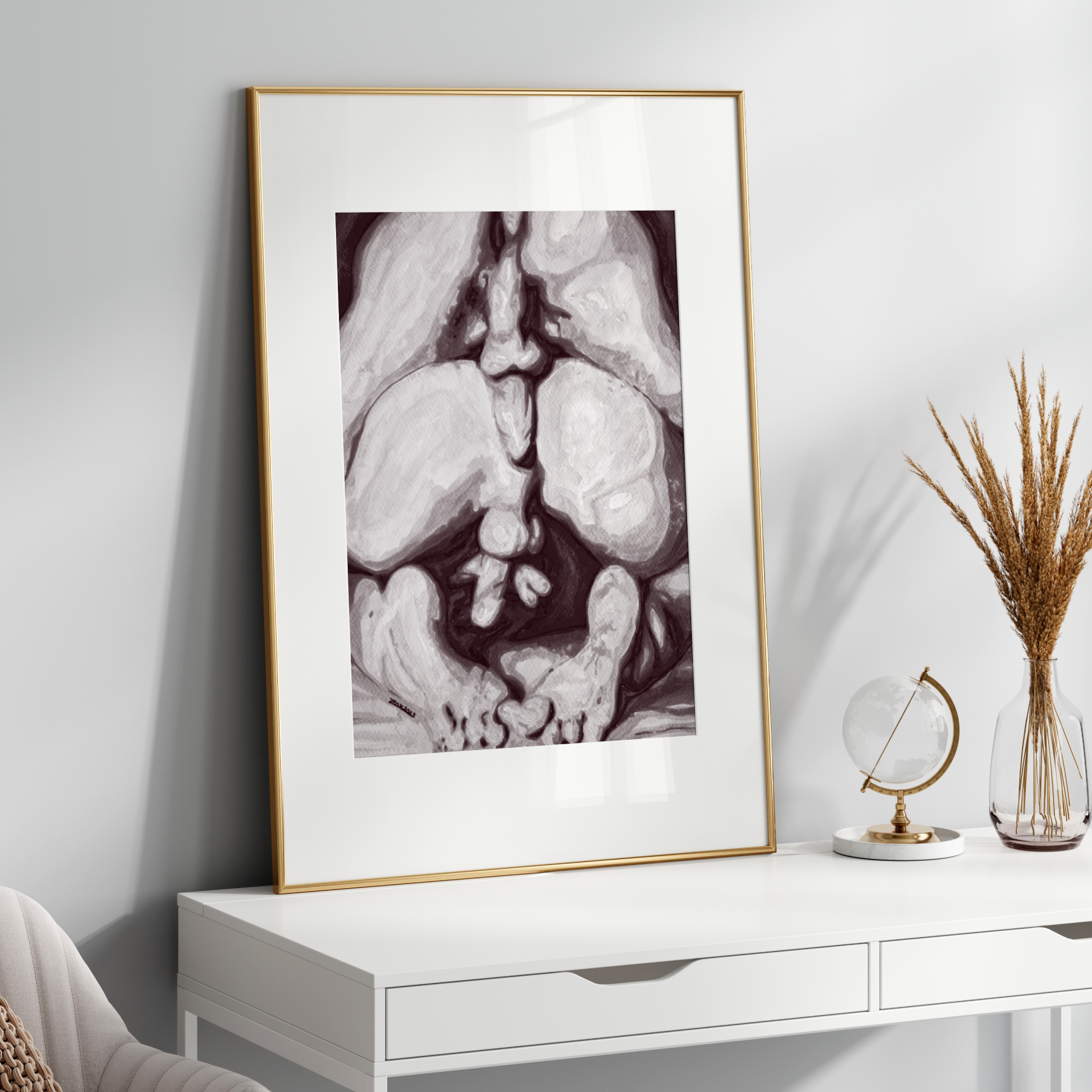 Framed artwork on a white wall above a white console table with decorative items.