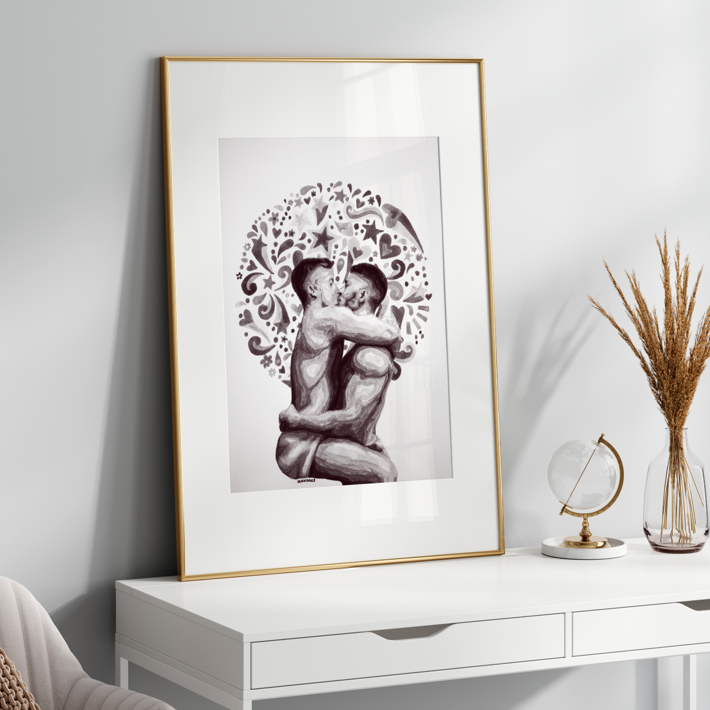 Framed black and white artwork of two people embracing on a white wall above a white console table.