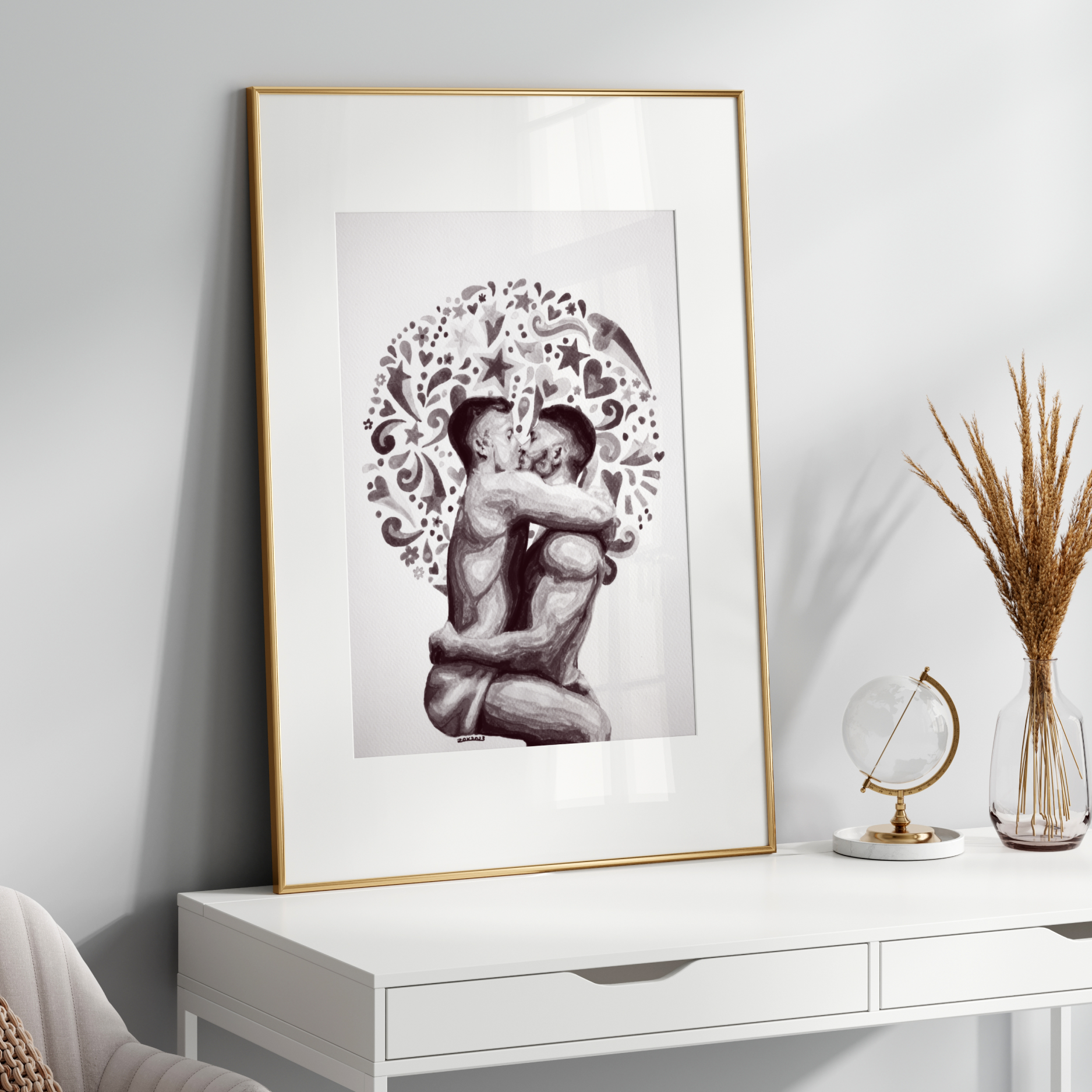 Framed black and white artwork of two people embracing on a white wall above a white console table.