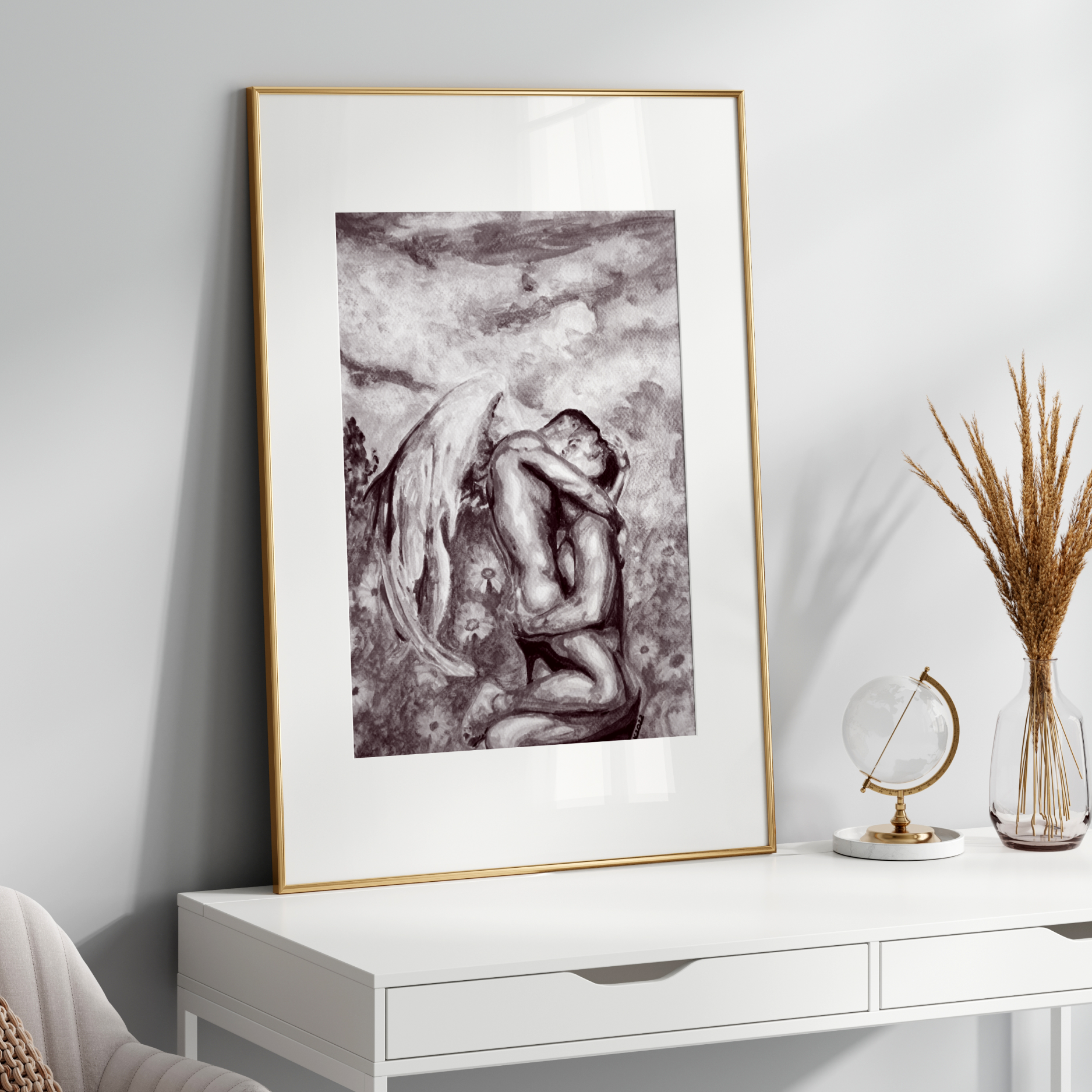 Framed artwork on a white wall above a white console table with decorative items.