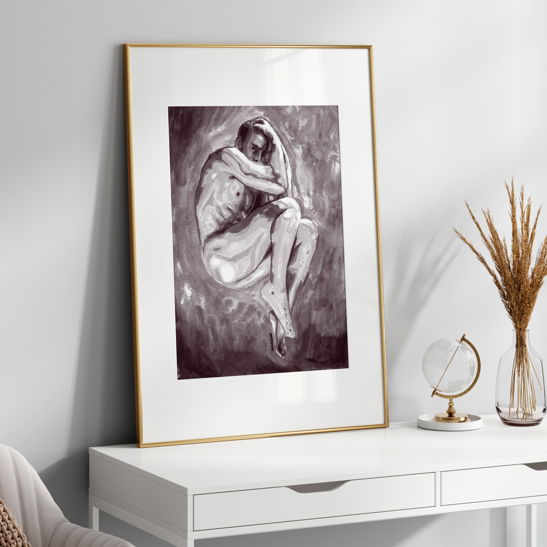 Framed black and white artwork on a white wall above a white console table.