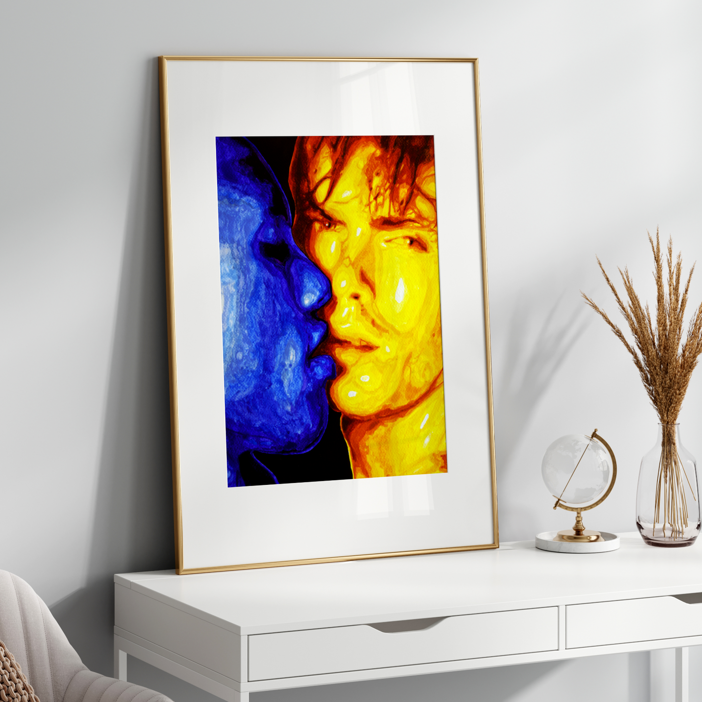 Framed abstract art on a white wall above a white console table.