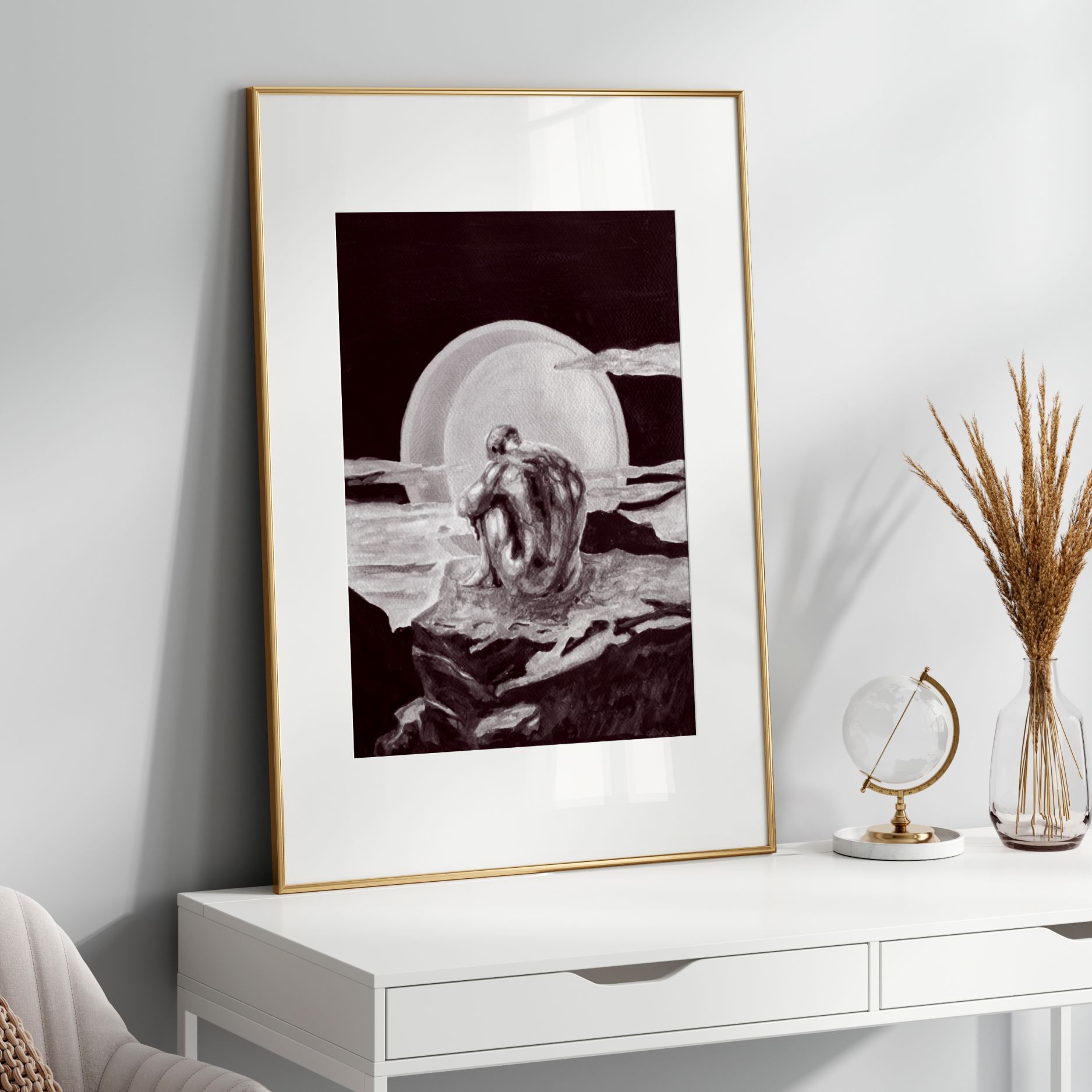 Framed black and white artwork on a white wall above a white console table with decorative items.