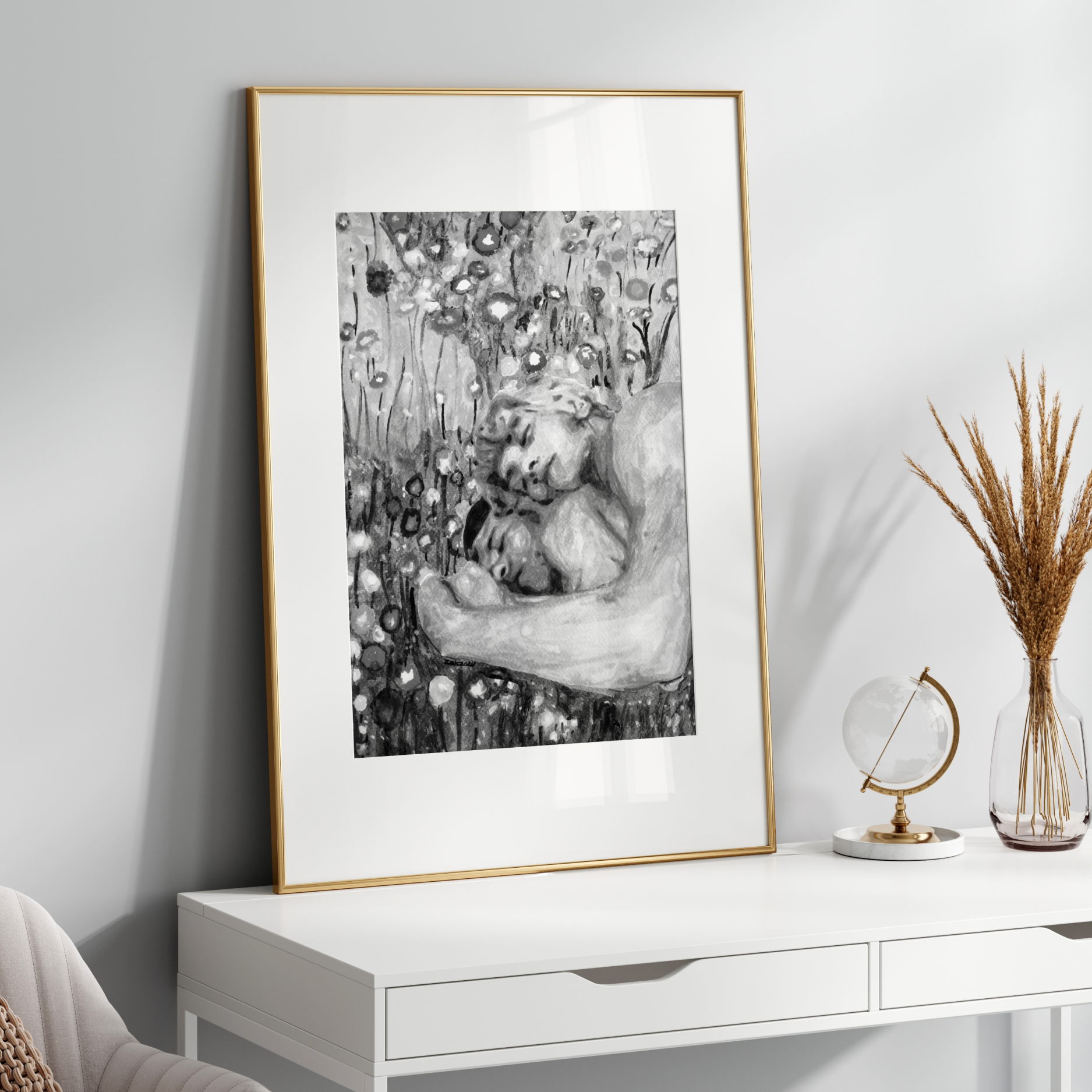 Framed black and white artwork on a white wall above a white console table with decorative items.