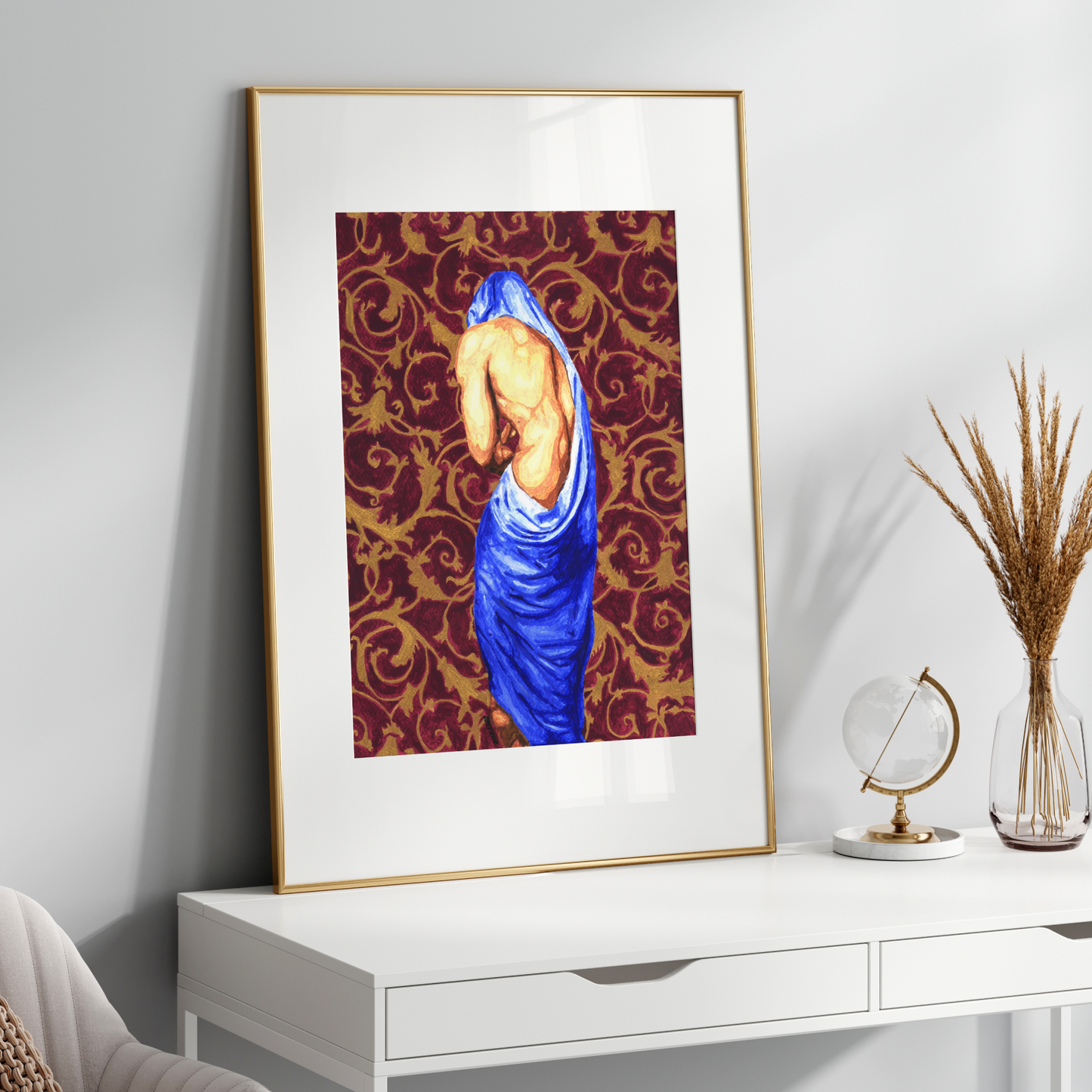Framed artwork on a wooden console table with decorative elements.