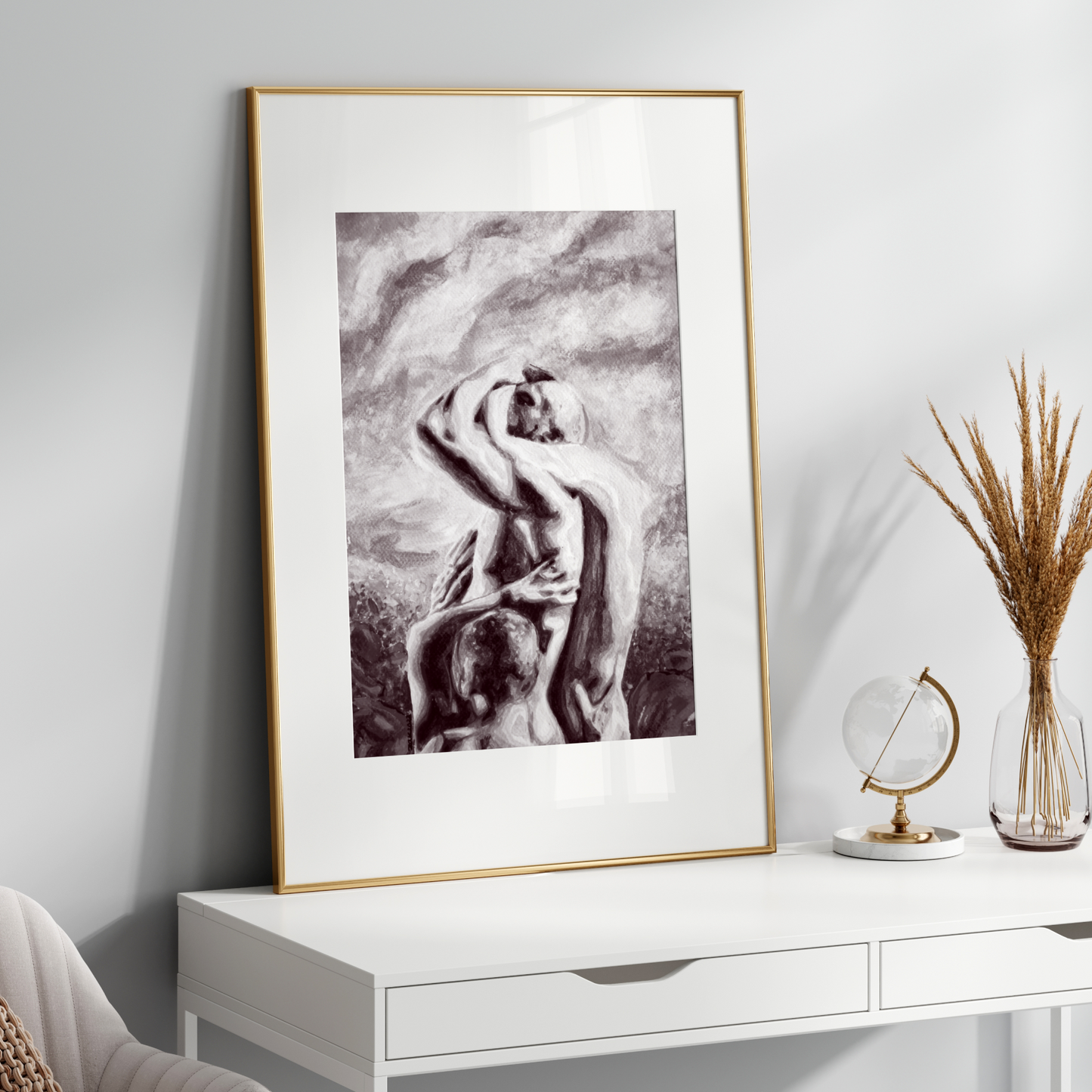 Framed artwork on a white wall above a white console table with decorative items.