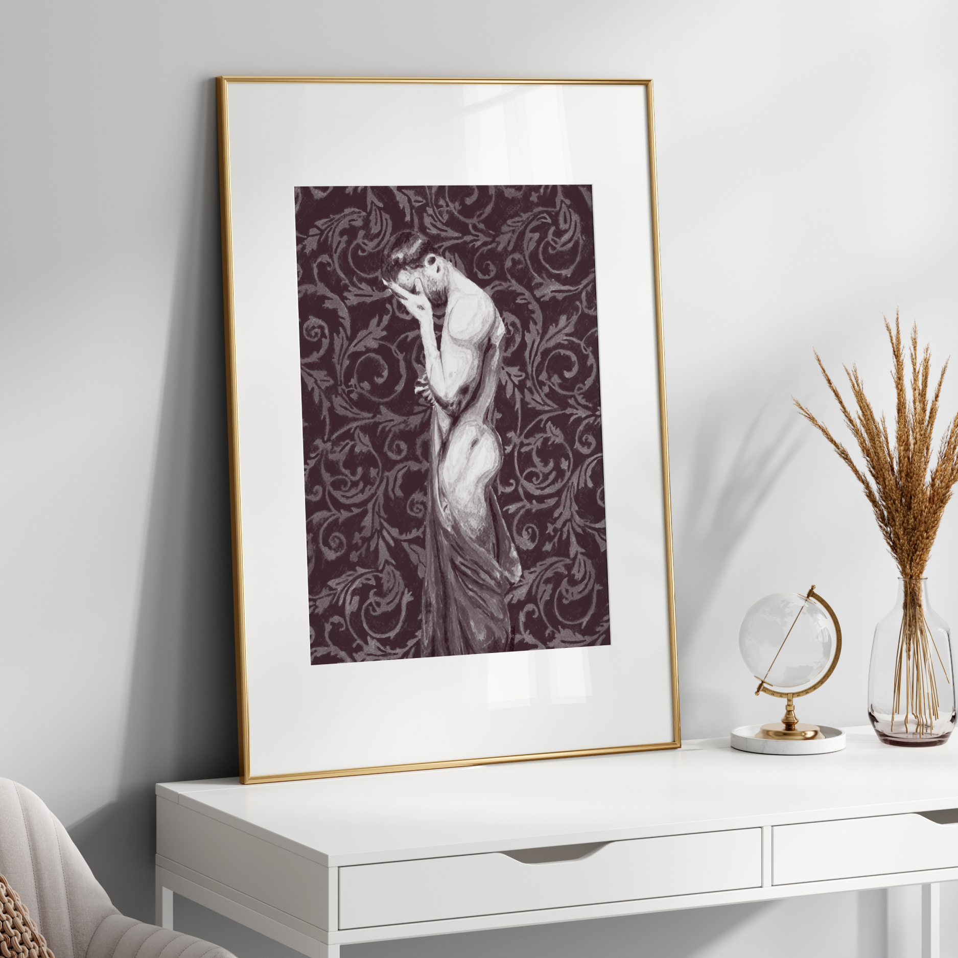 Framed artwork on a white wall above a white console table with decorative items.