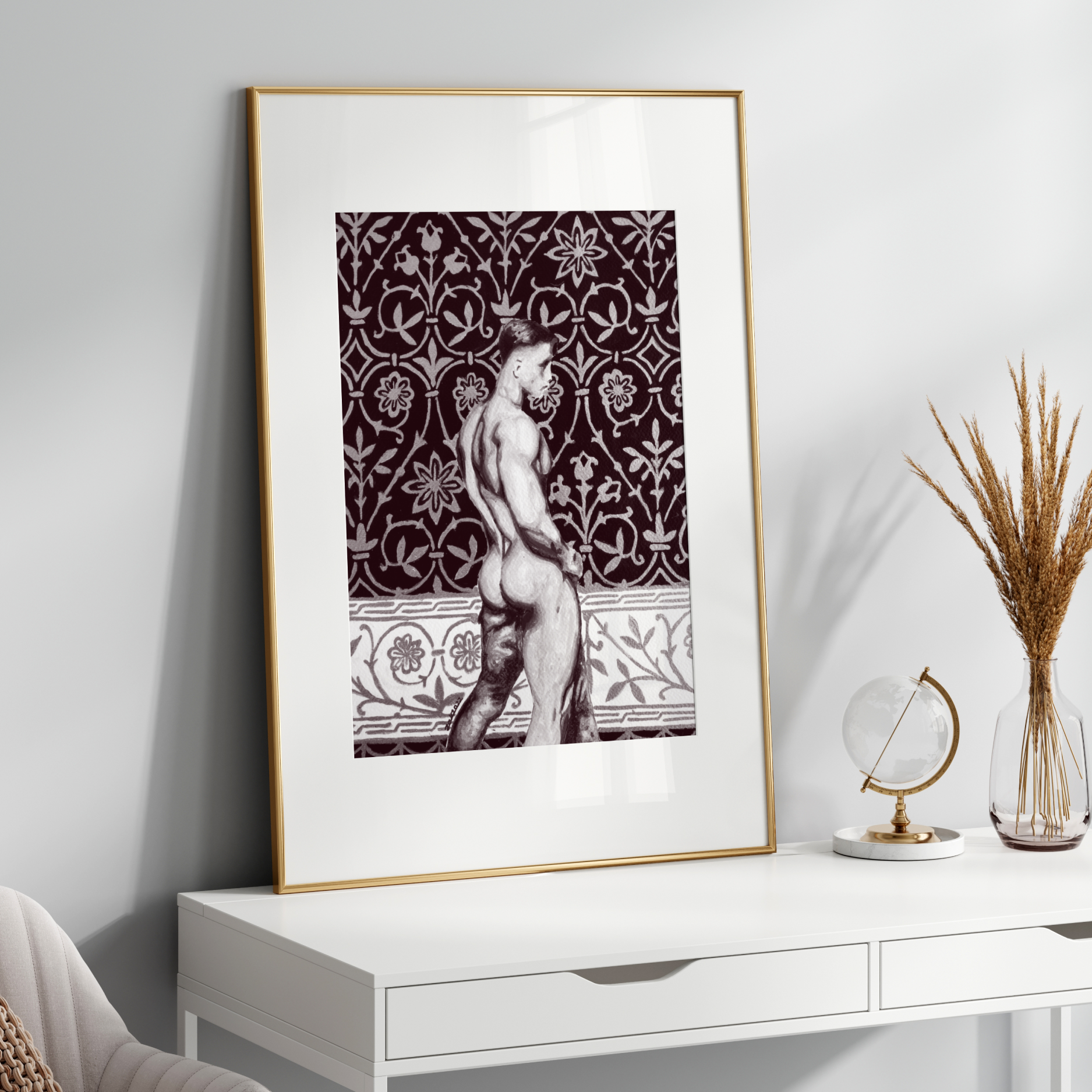 Framed artwork on a white wall above a white console table with decorative items.