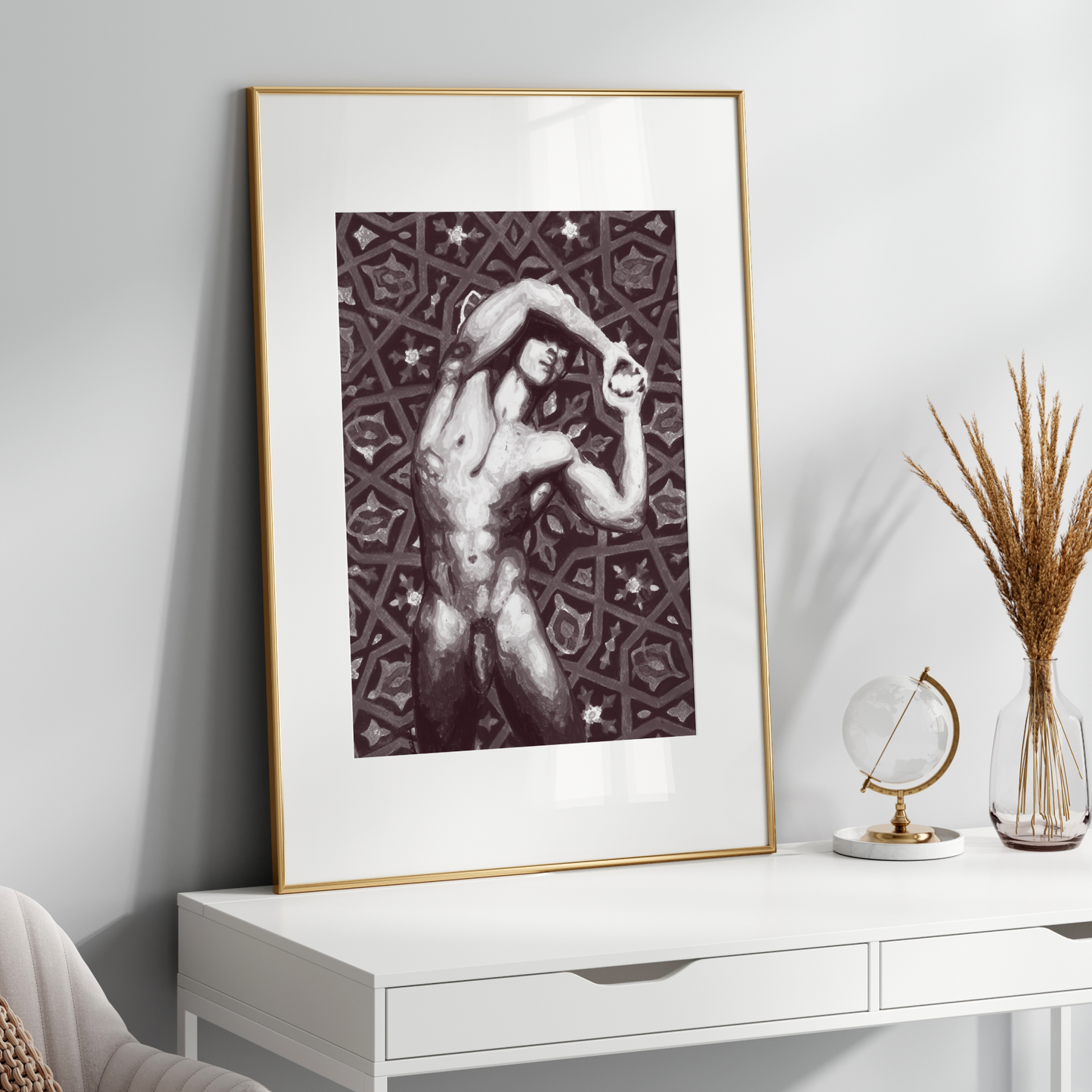 Framed artwork on a wooden console table with decorative elements against a  wall.