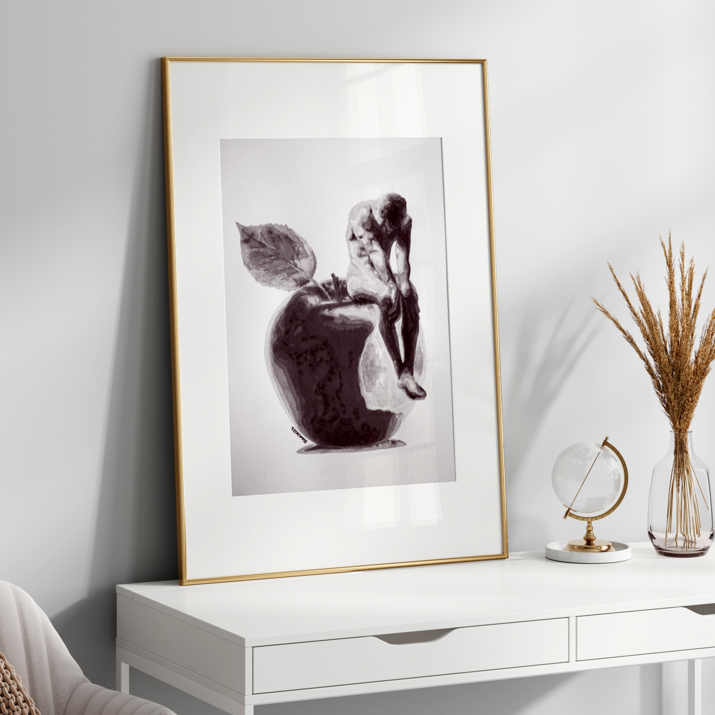 Framed artwork on a white wall above a white console table with decorative items.
