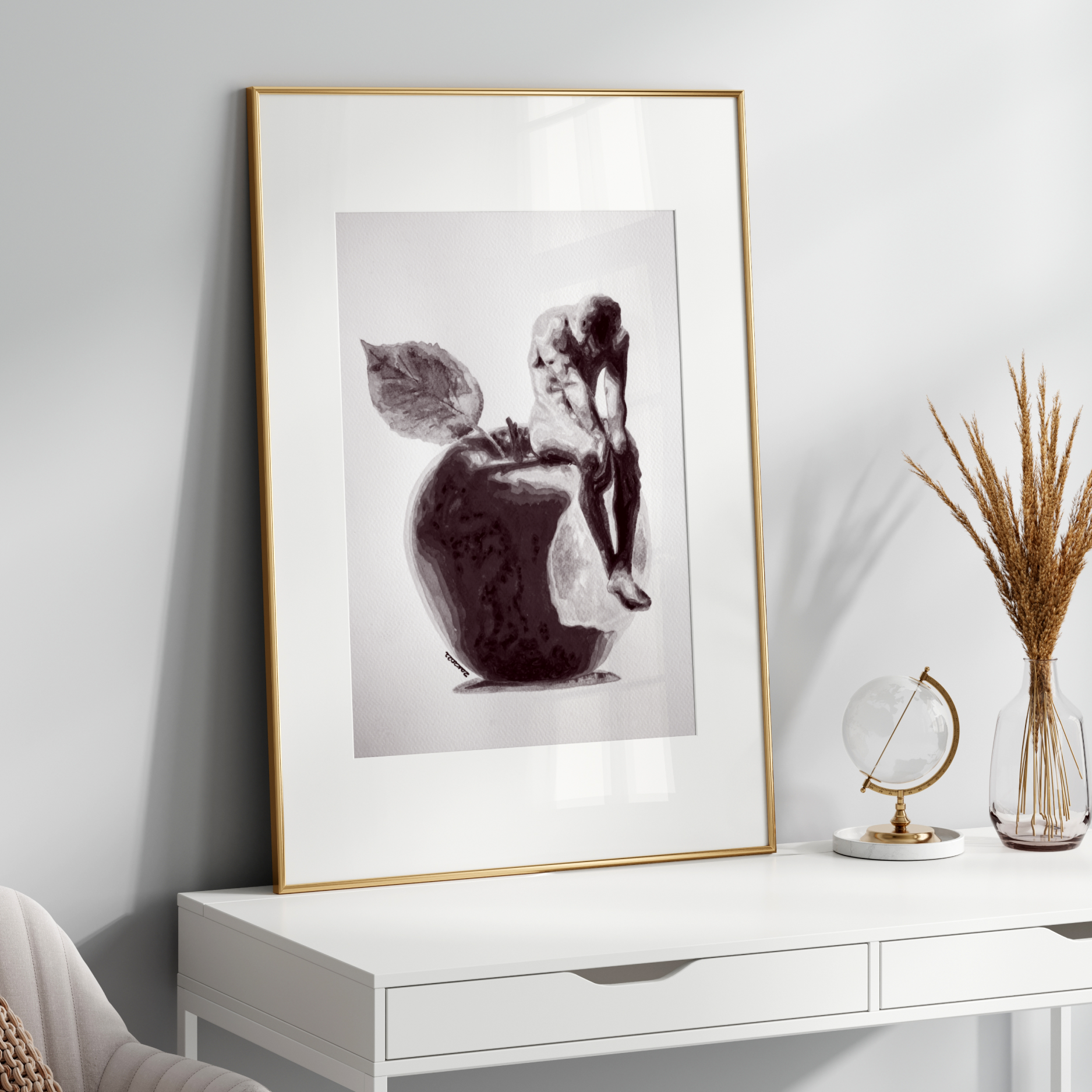 Framed artwork on a white wall above a white console table with decorative items.