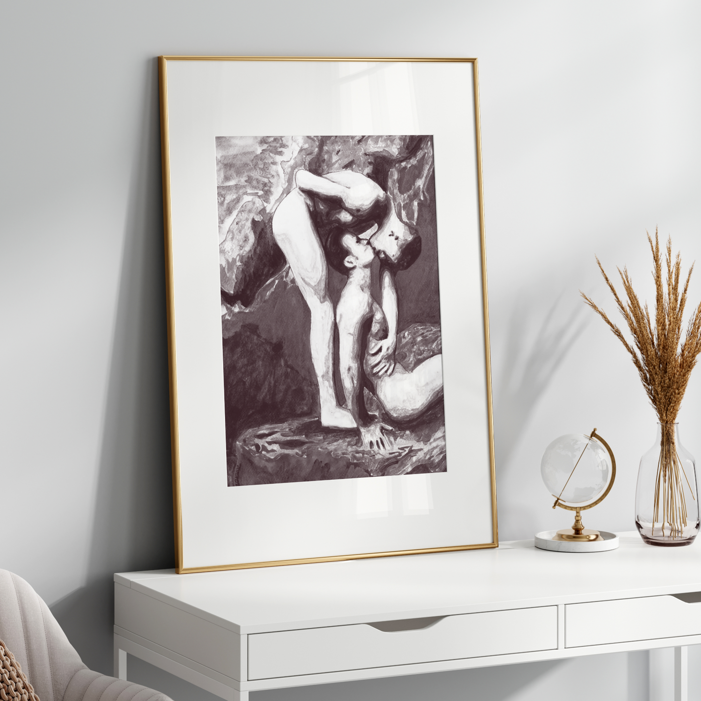 Framed black and white artwork on a white wall above a white console table with decorative items.