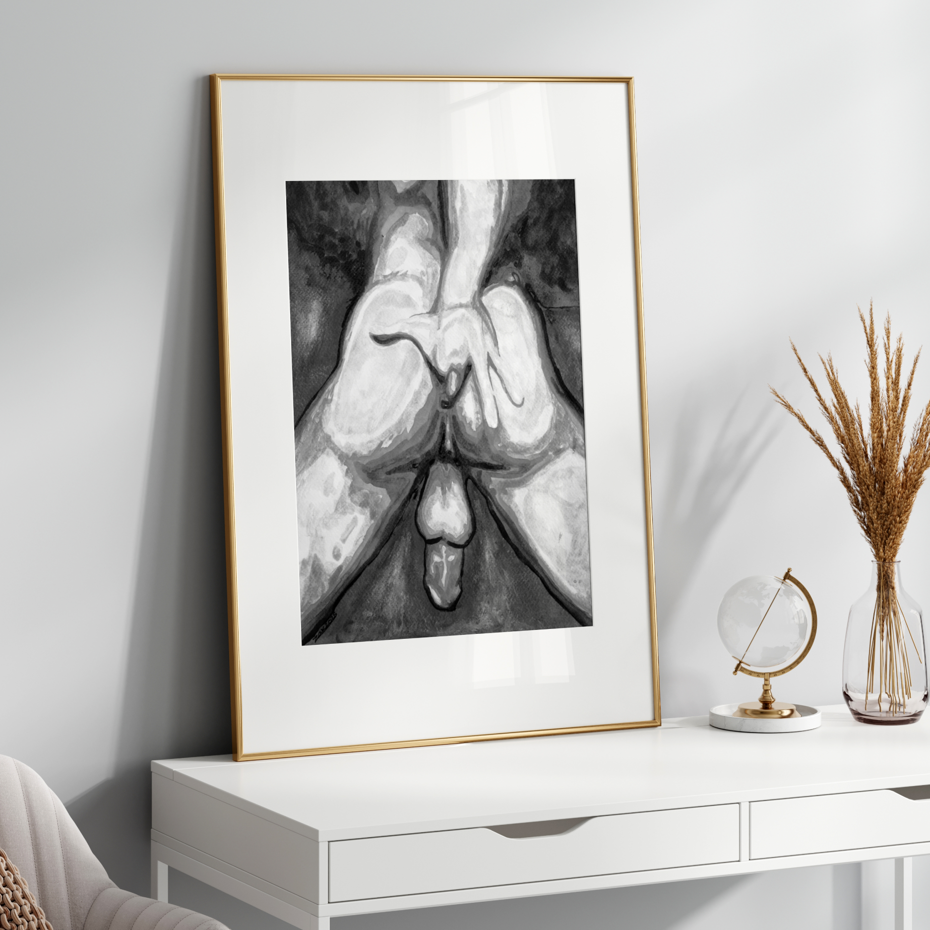 Framed black and white artwork on a white wall above a white console table.