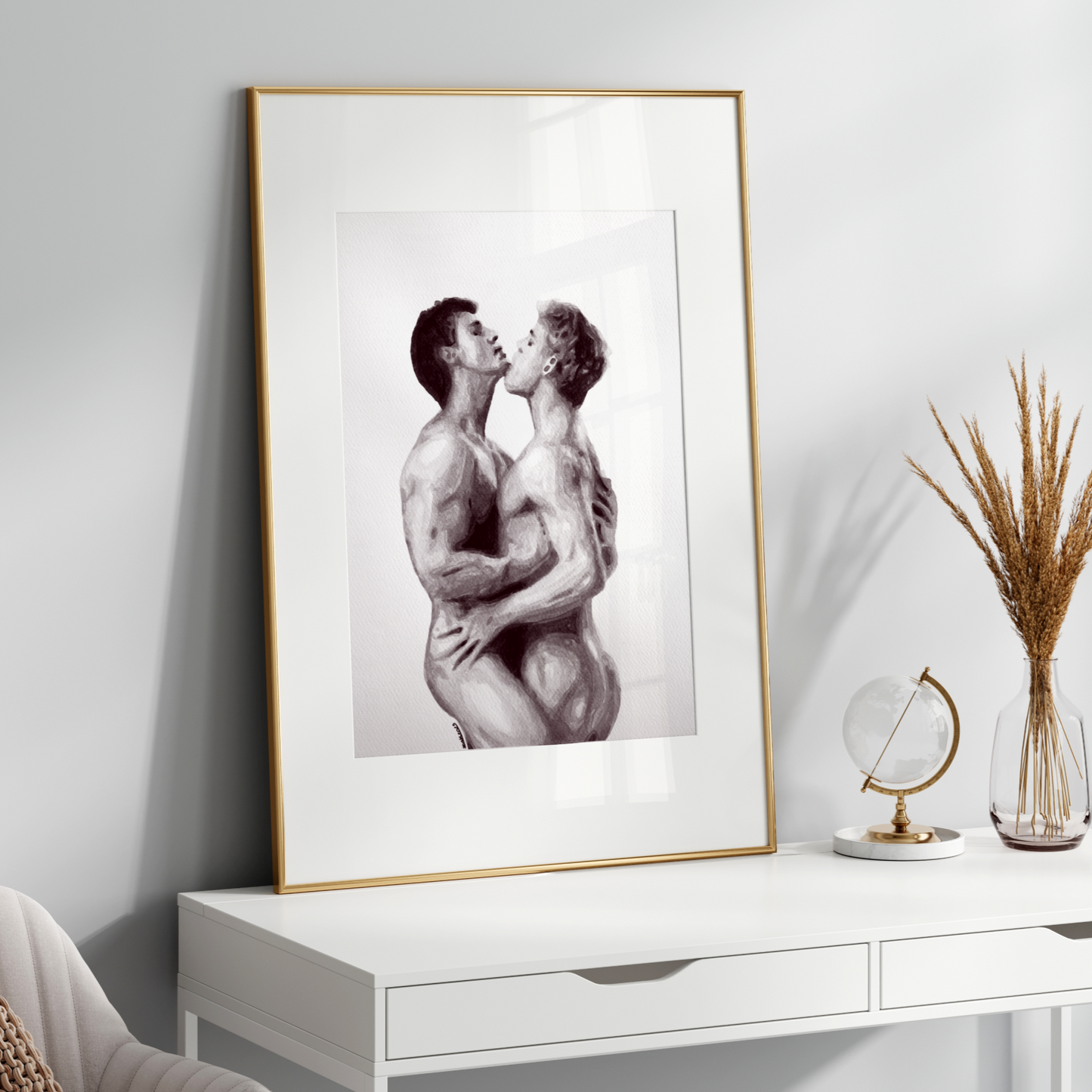 Framed artwork of two people embracing on a white wall above a white console table.