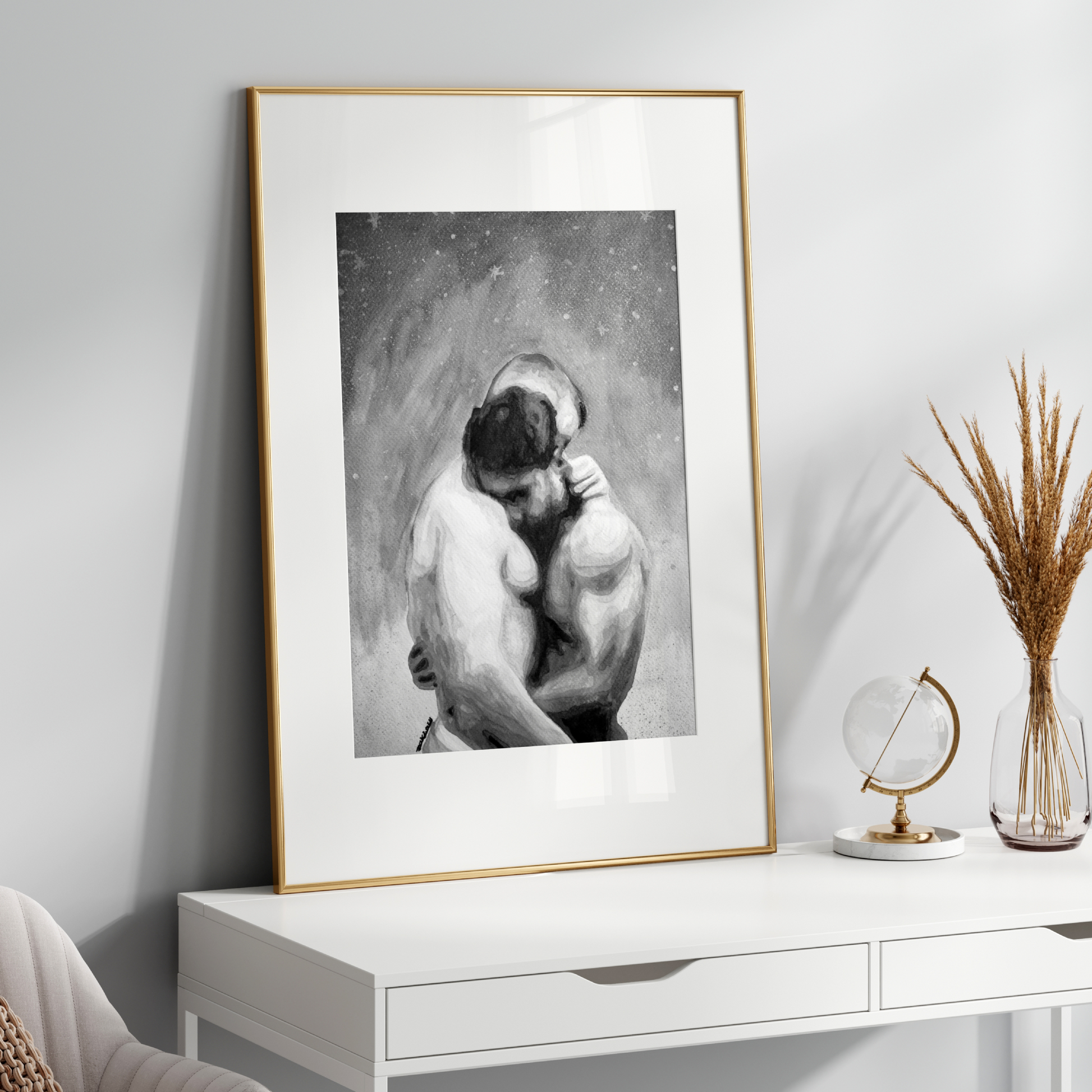 Framed black and white artwork on a white wall above a white console table with decorative items.