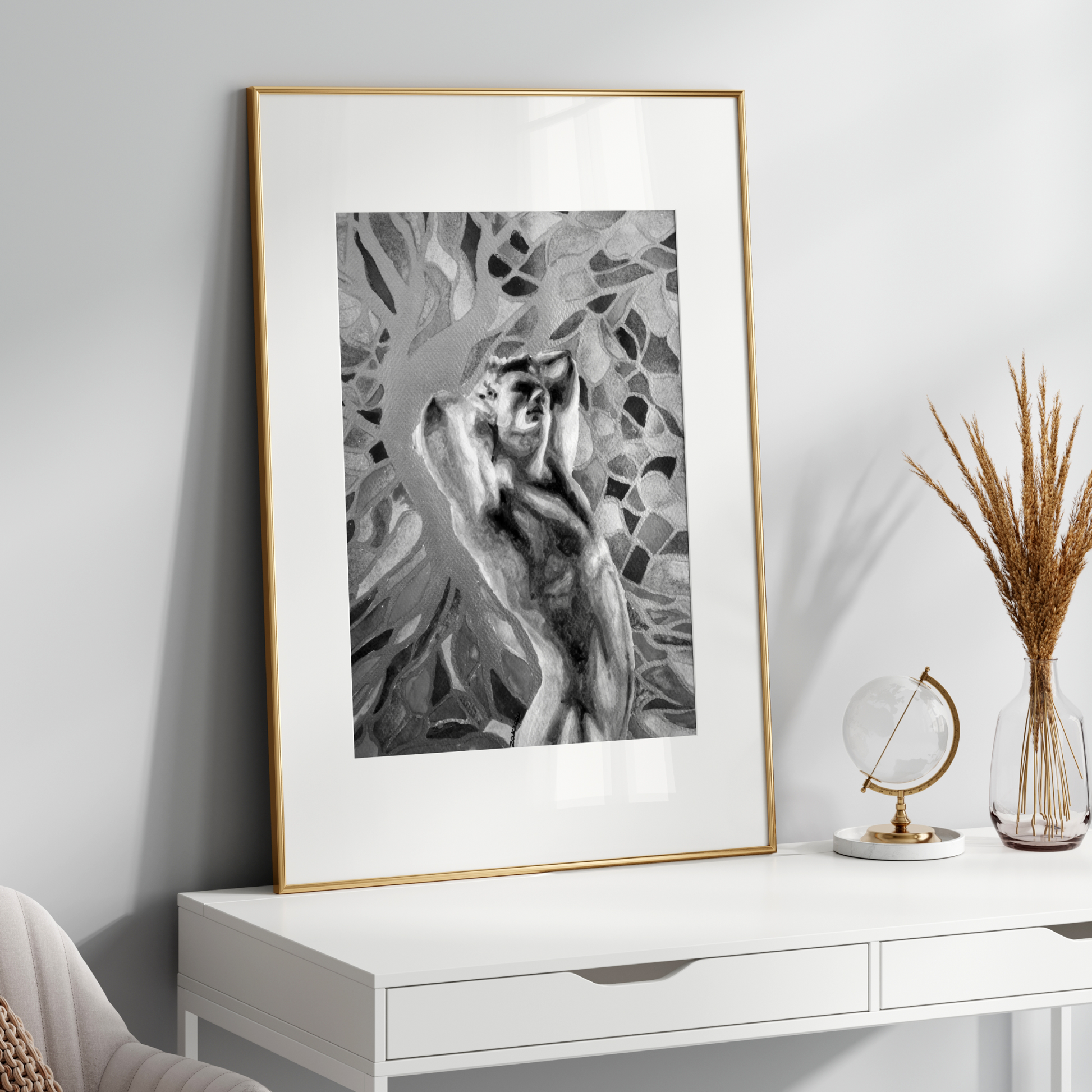Framed black and white artwork on a white wall above a white console table with decorative items.