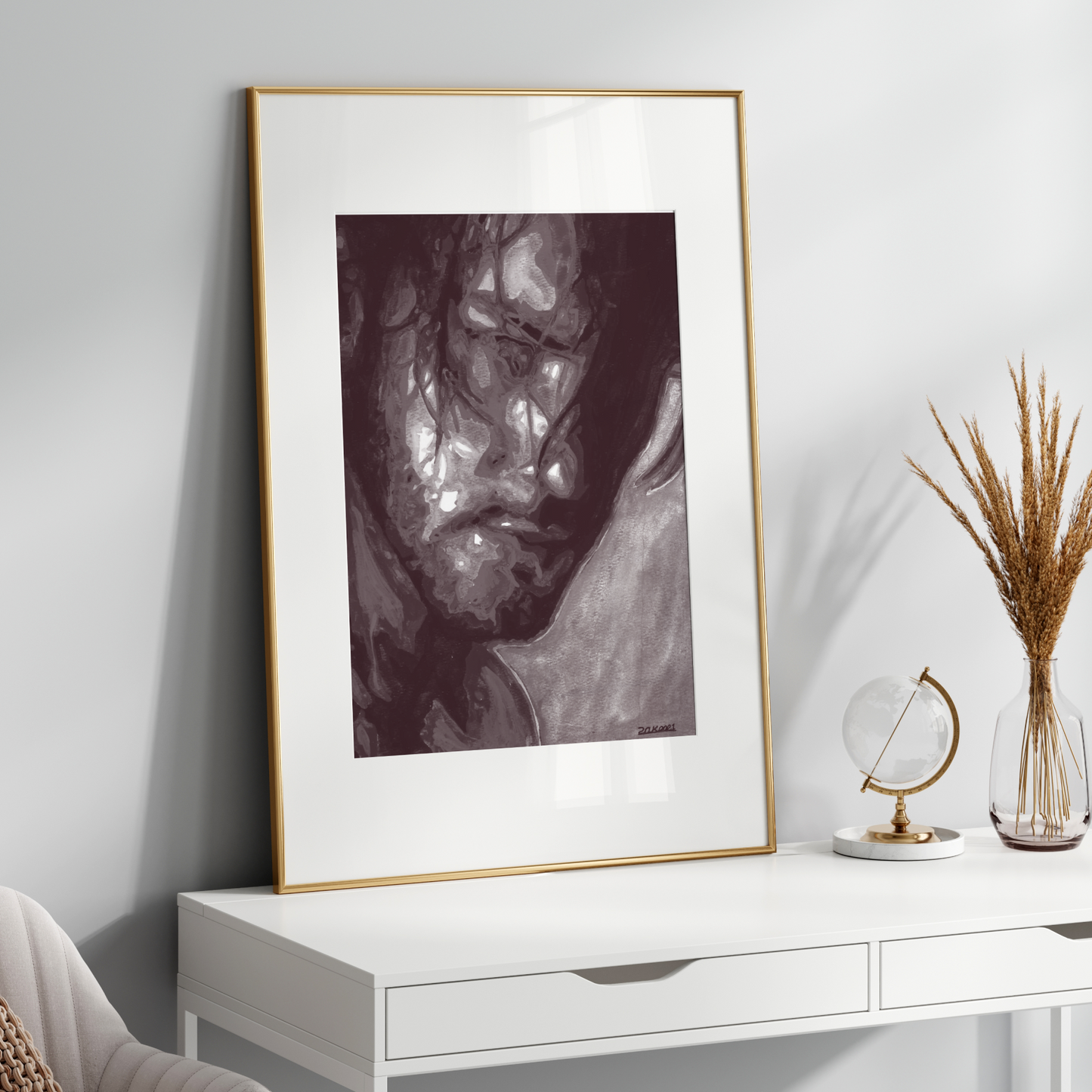 Framed artwork on a white wall above a white console table with decorative items.