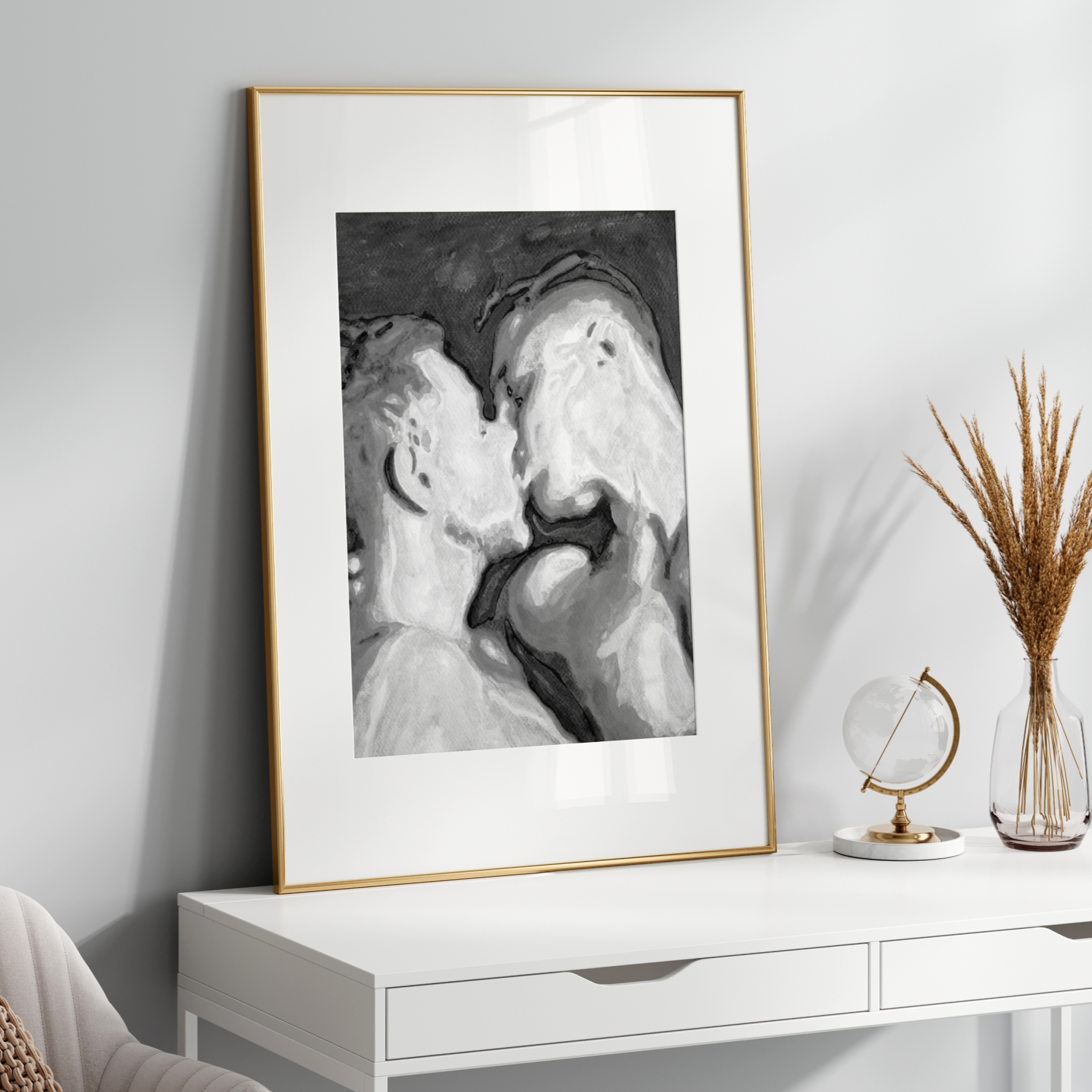 Framed black and white abstract art on a white wall above a white console table.