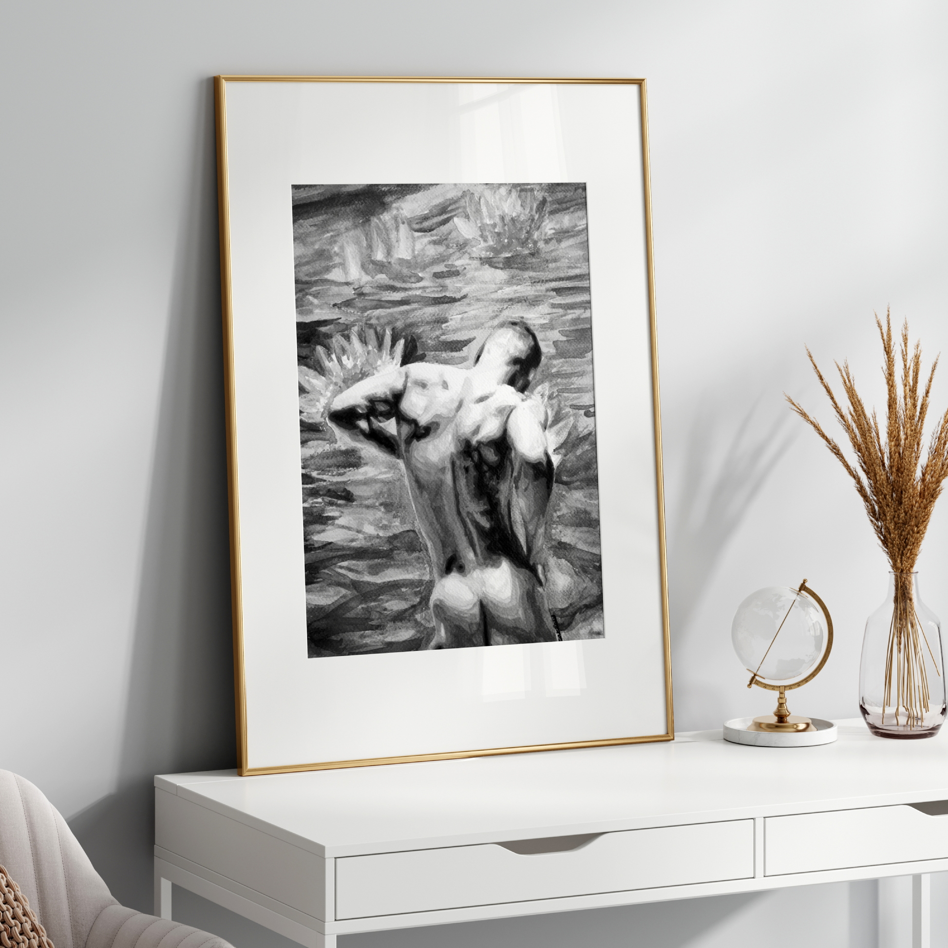 Framed black and white artwork on a white wall above a white console table.