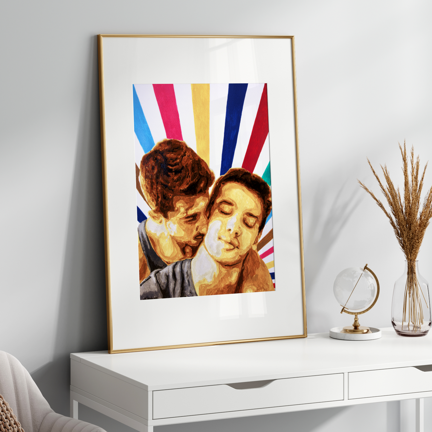 Framed artwork of two people kissing with colorful stripes on a white wall above a white console table.