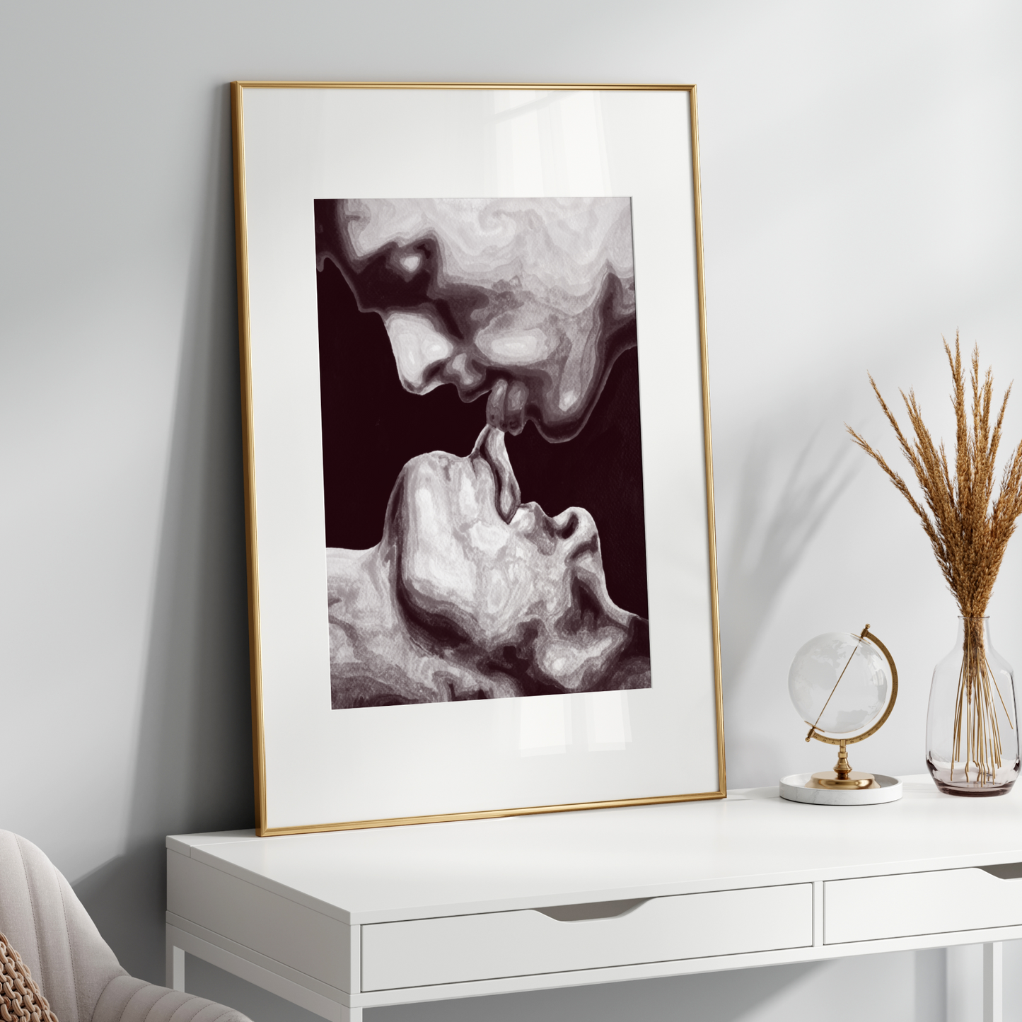 Framed black and white artwork on a white wall above a white console table.