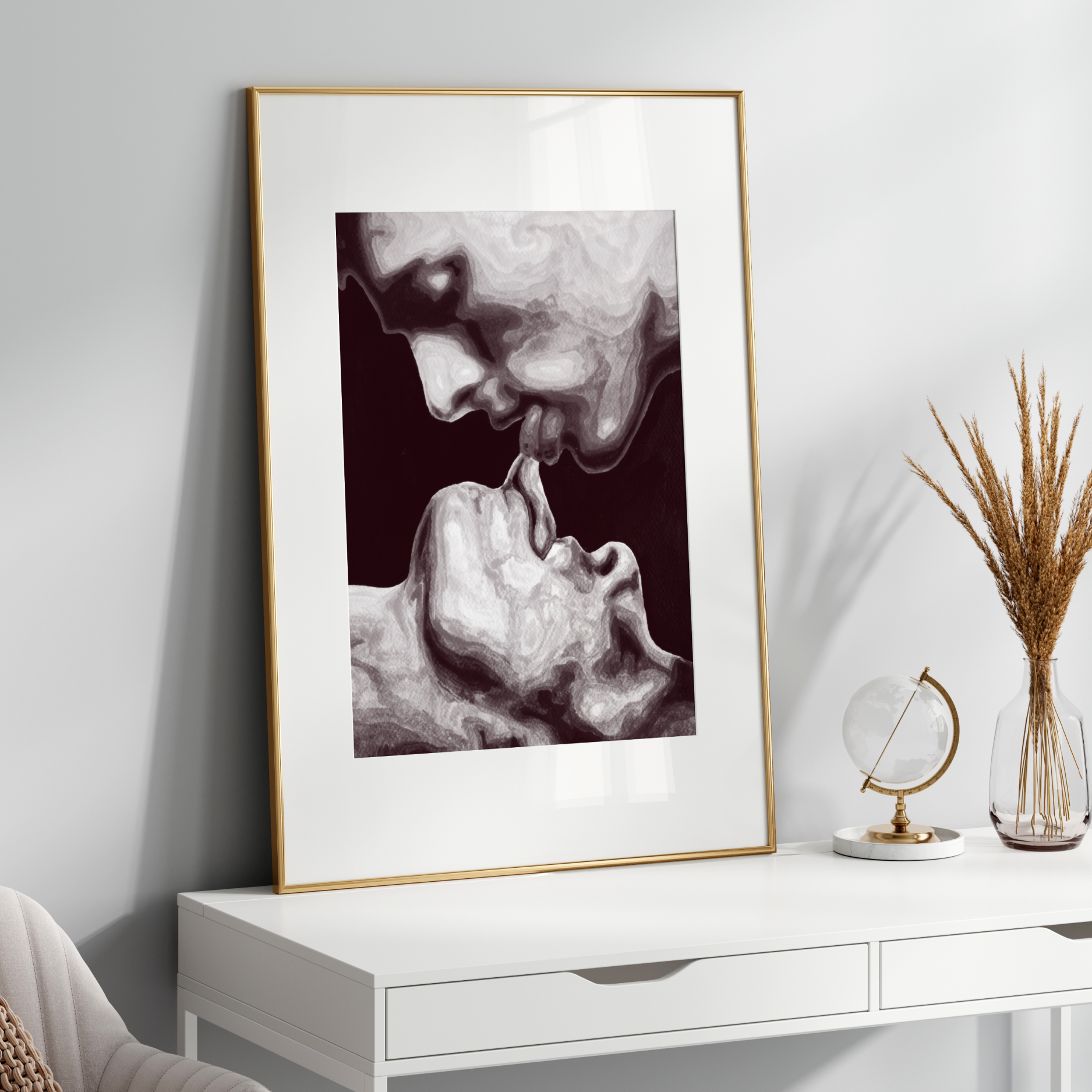 Framed black and white artwork on a white wall above a white console table.