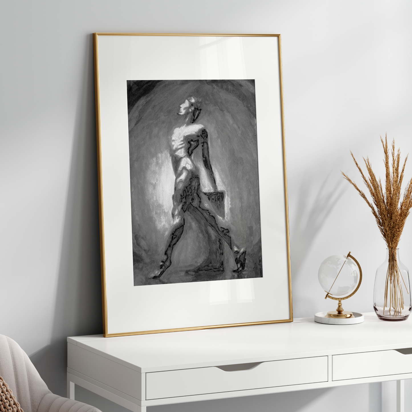 Framed black and white artwork on a white wall above a white console table with decorative items.
