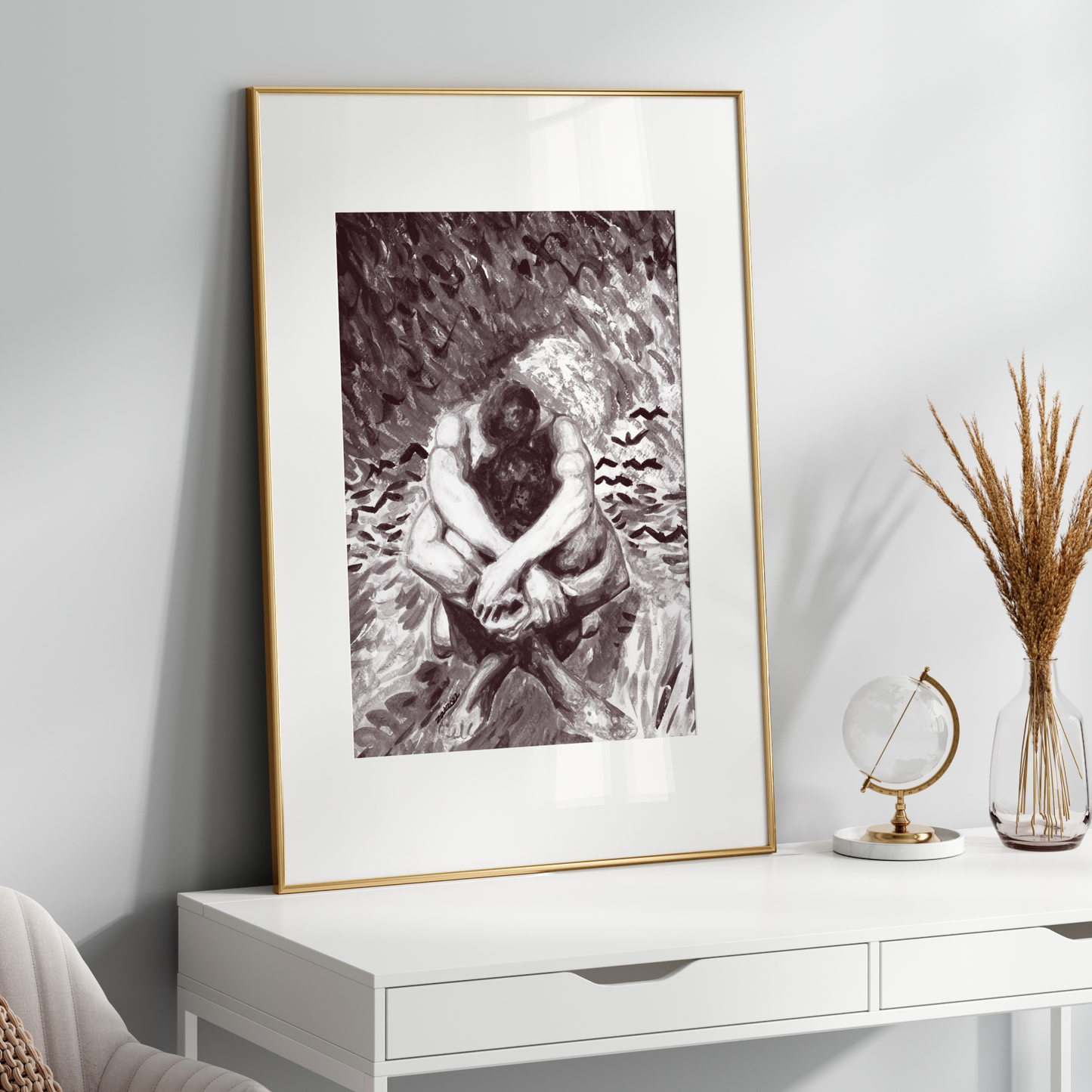 Framed black and white artwork on a white wall above a white console table with decorative items.