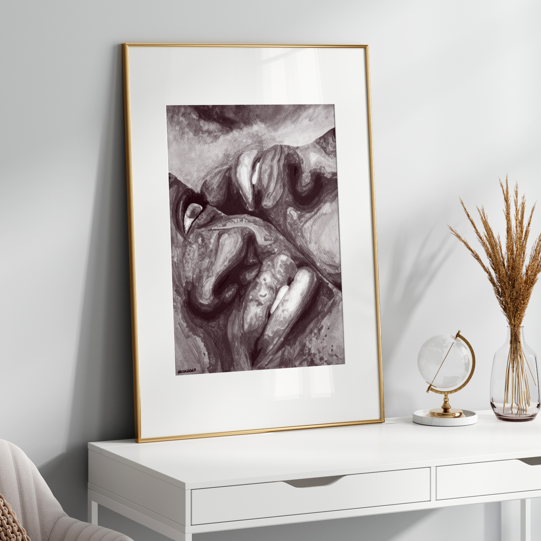 Framed black and white artwork on a white wall above a white console table.