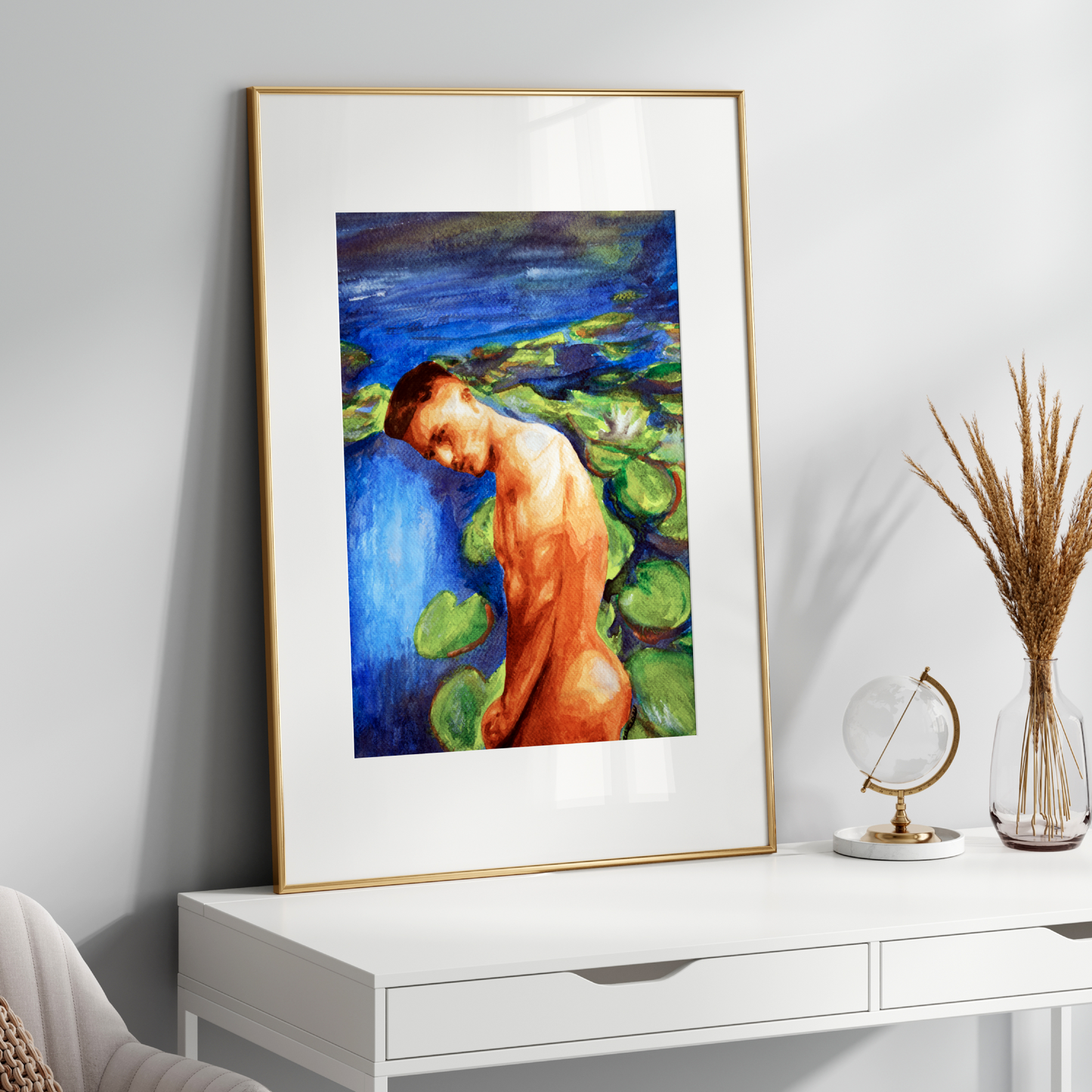Framed artwork of a nude figure on a white wall above a white console table.