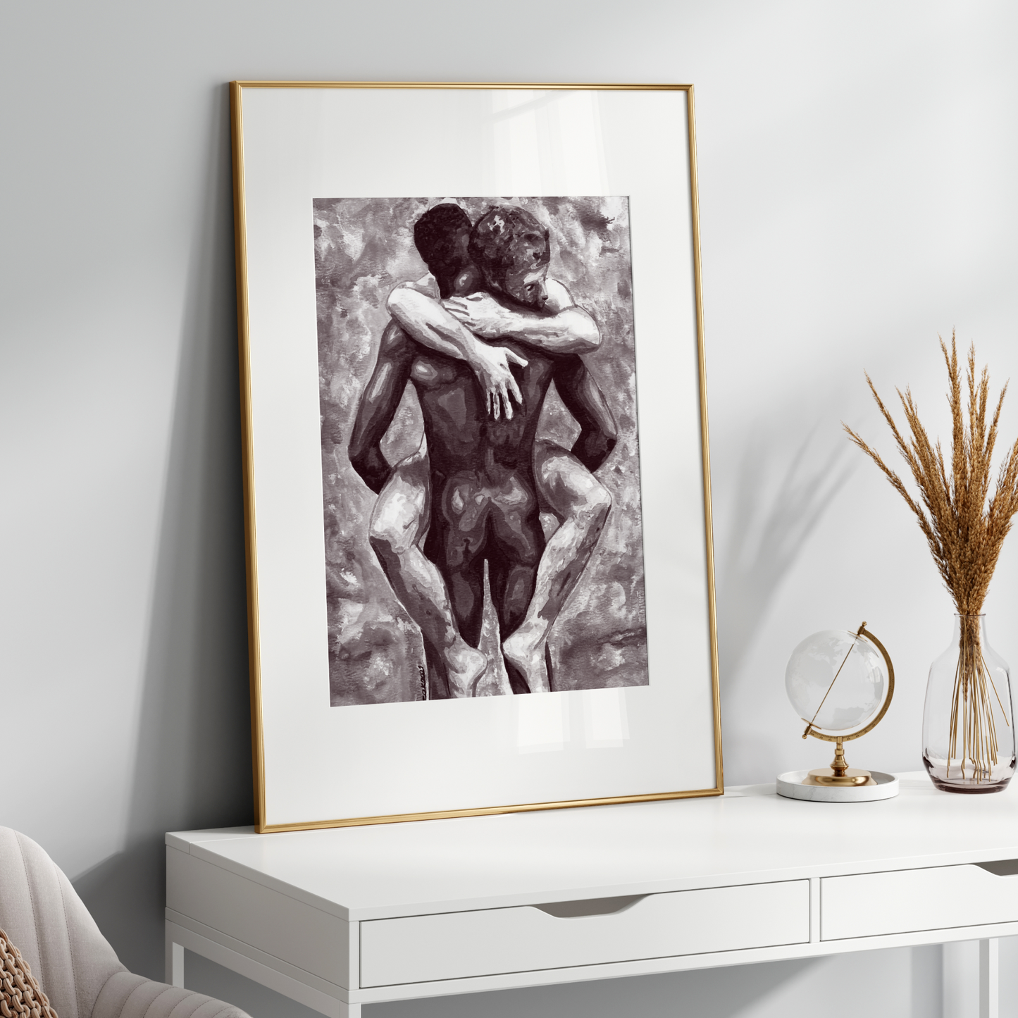 Framed artwork of two embracing figures on a white wall above a white console table.