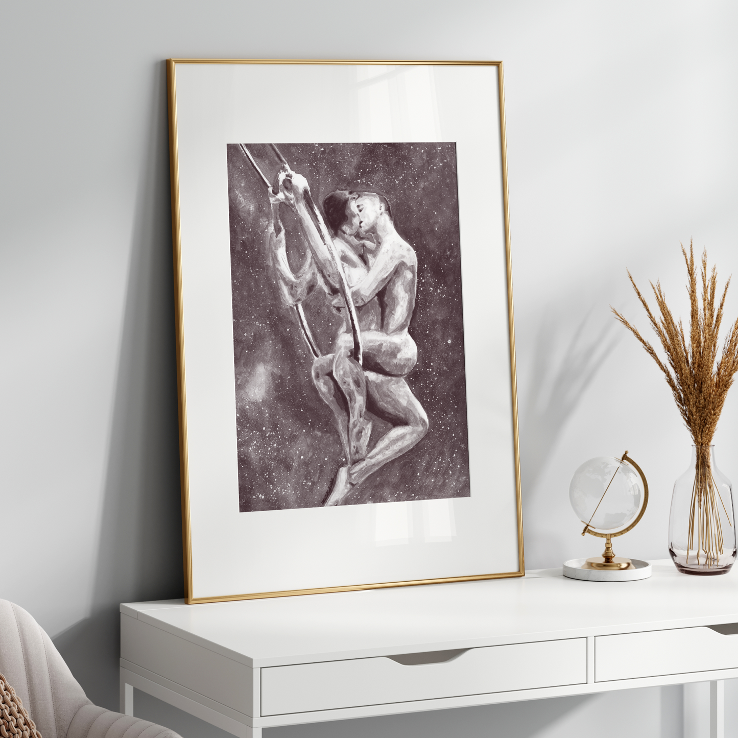 Framed artwork on a white wall above a white console table with decorative items.