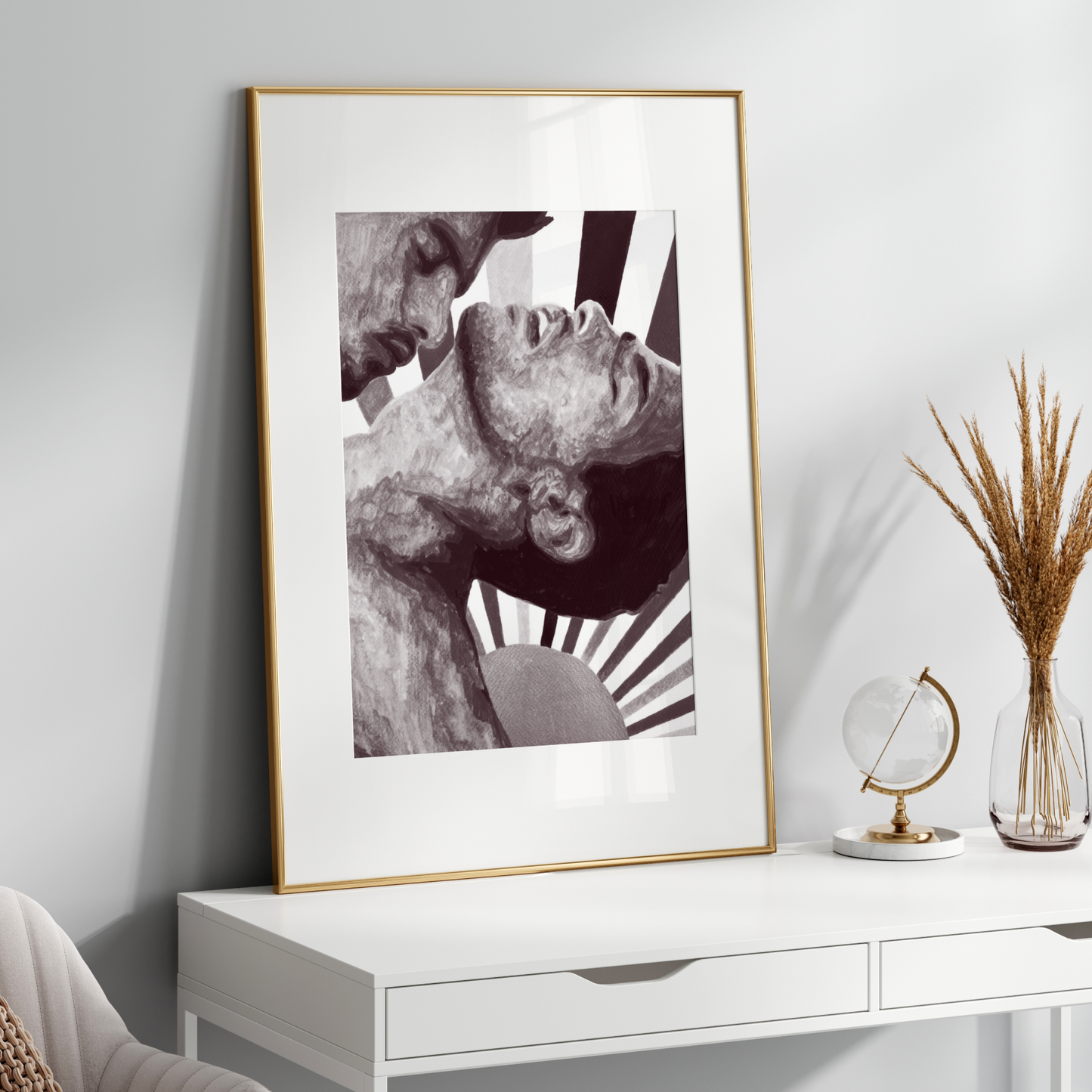 Framed artwork on a white wall above a white console table with decorative items.
