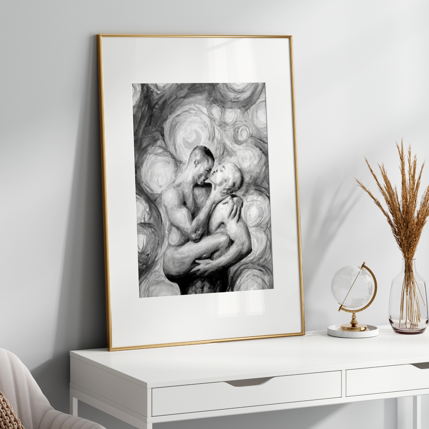 Framed black and white artwork on a white wall above a white console table.