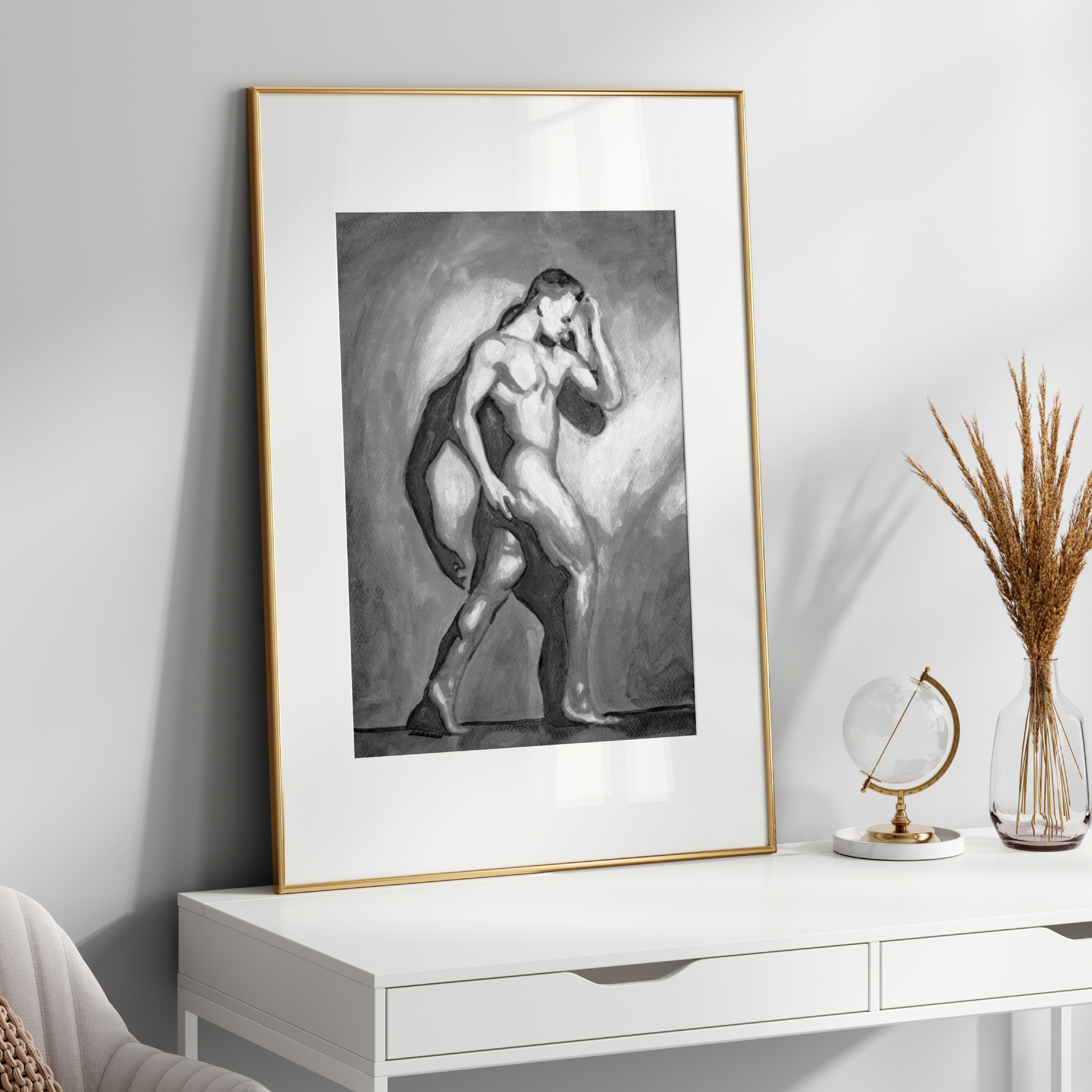 Framed black and white artwork of a nude figure on a white console table with decorative items.