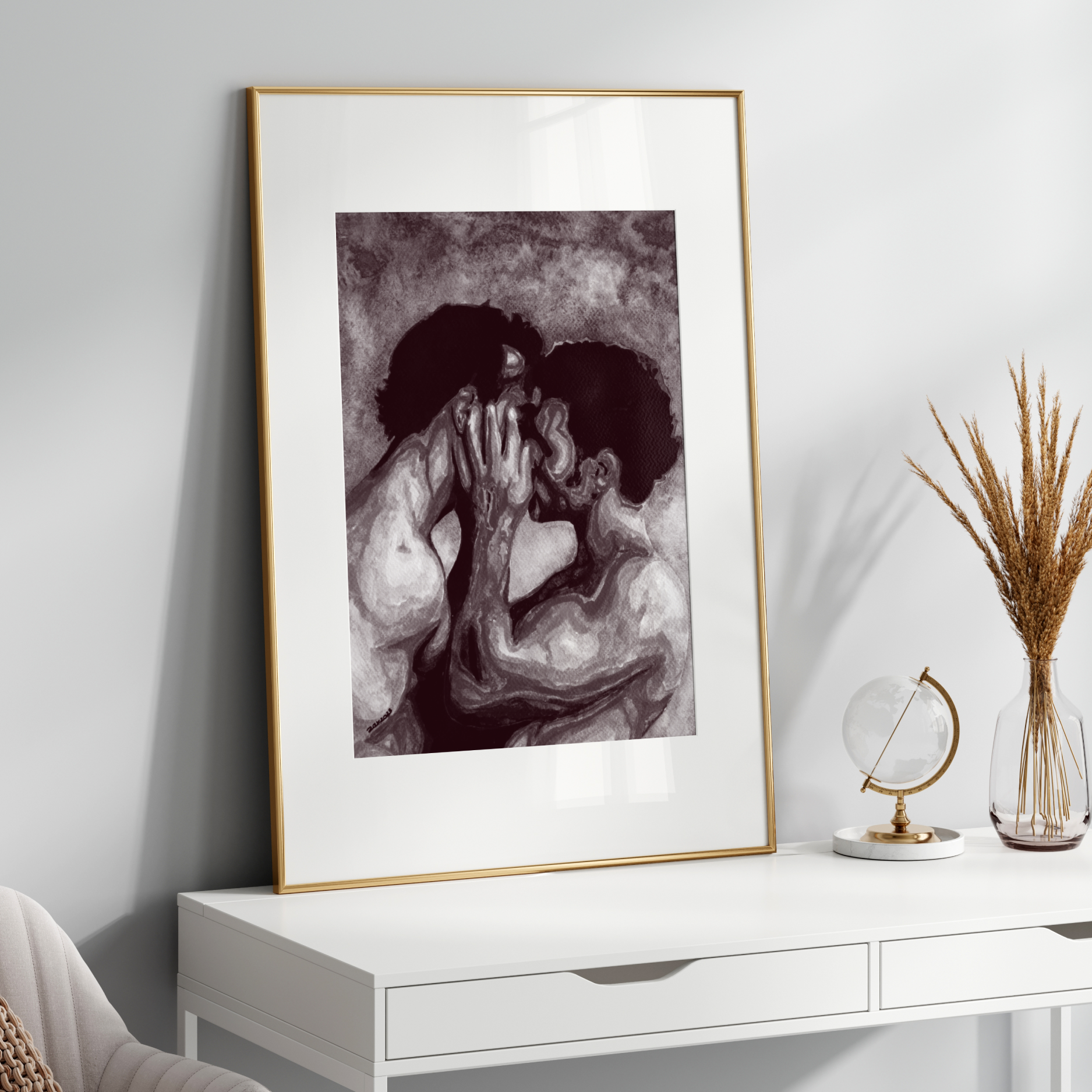 Framed artwork of two people embracing on a white wall above a white console table.