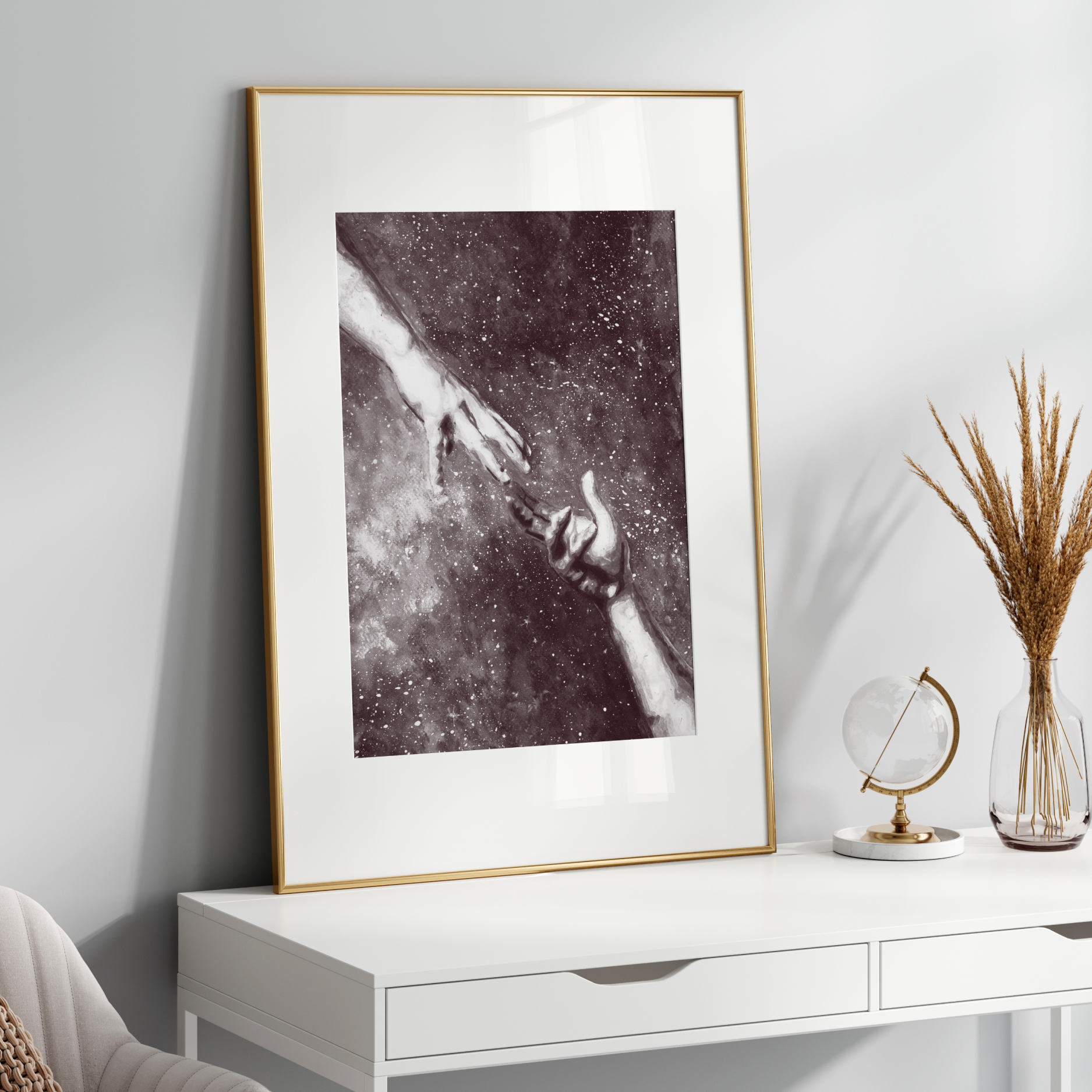 Framed artwork on a white wall above a white console table with decorative items.