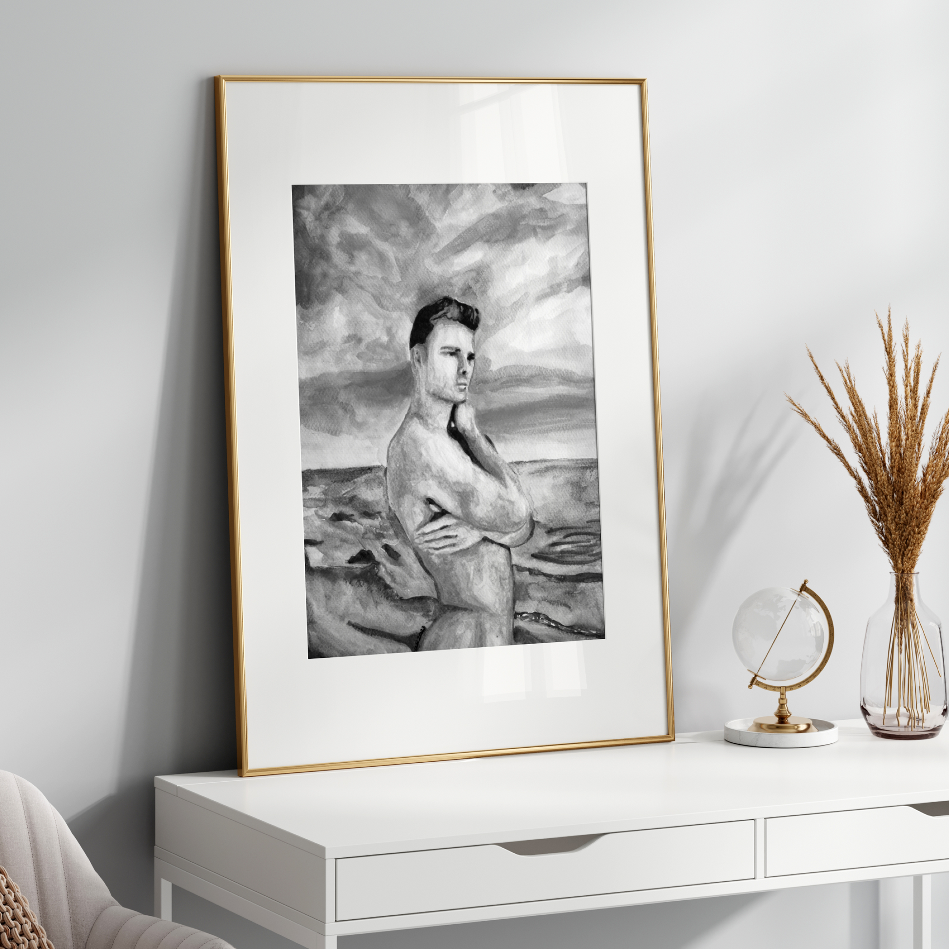 Framed black and white portrait on a white wall above a white console table with decorative items.