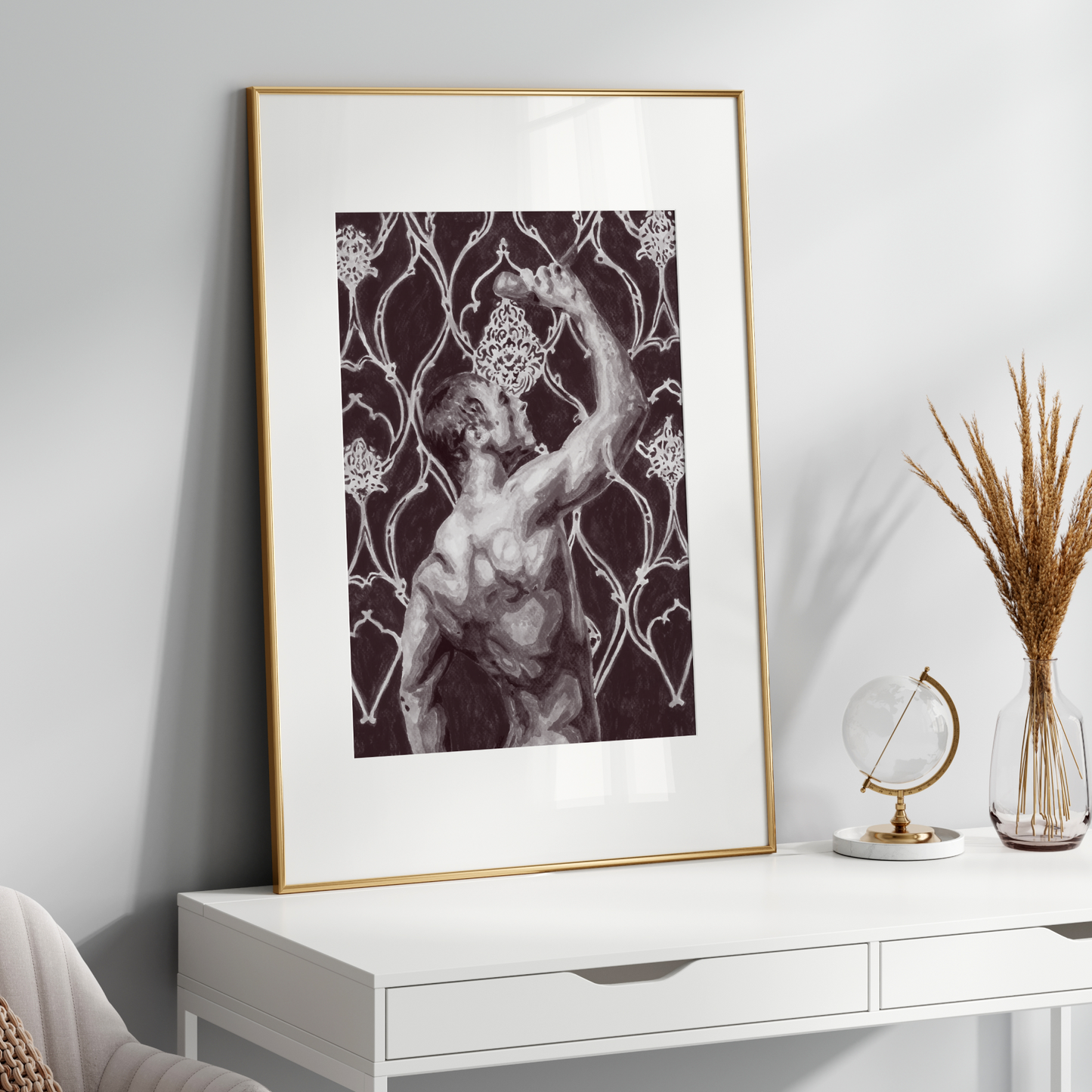 Framed artwork on a white wall above a white console table with decorative items.