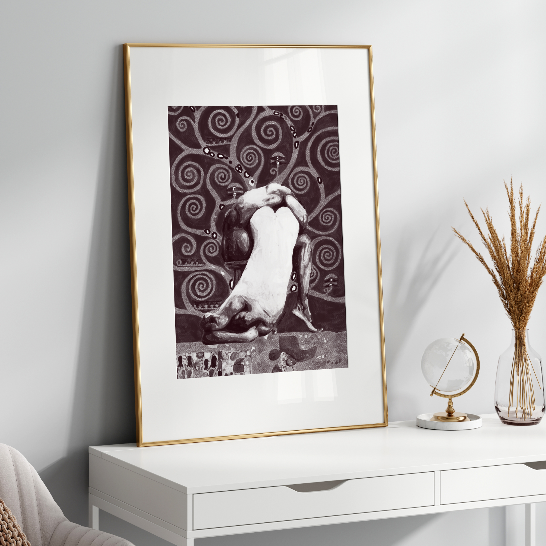 Framed artwork on a white wall above a white console table with decorative items.