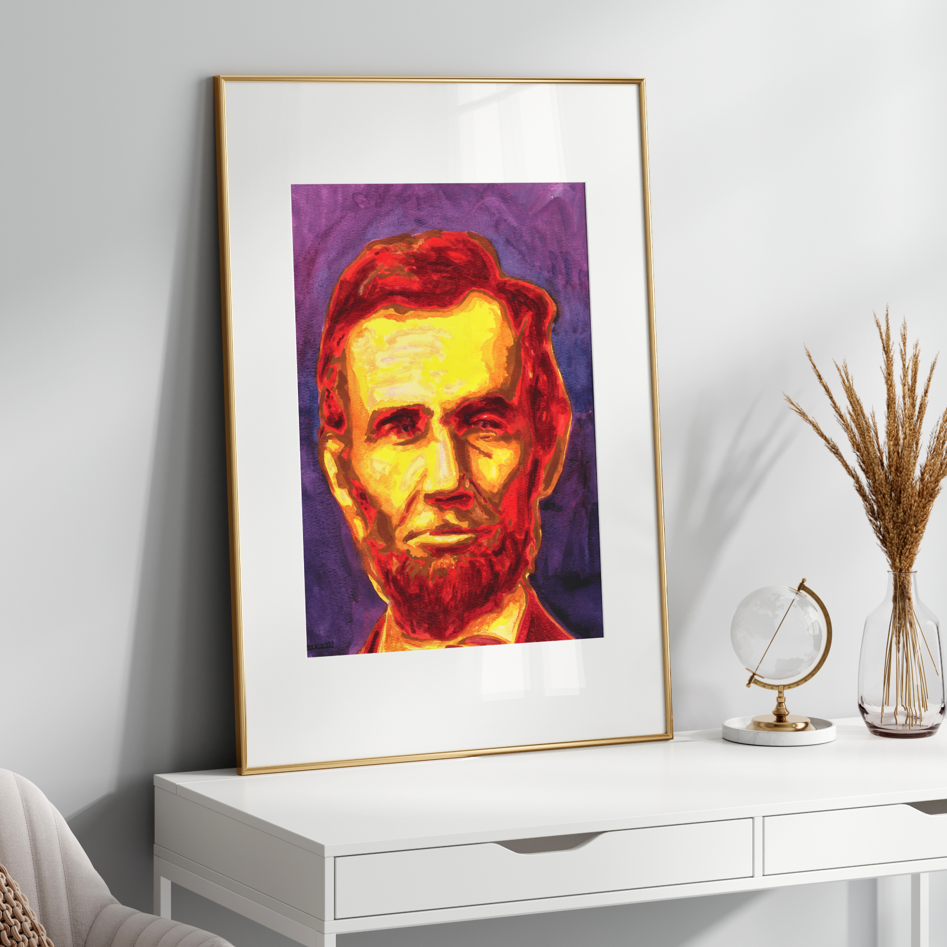 Framed portrait of a historical figure on a white surface with decorative items.