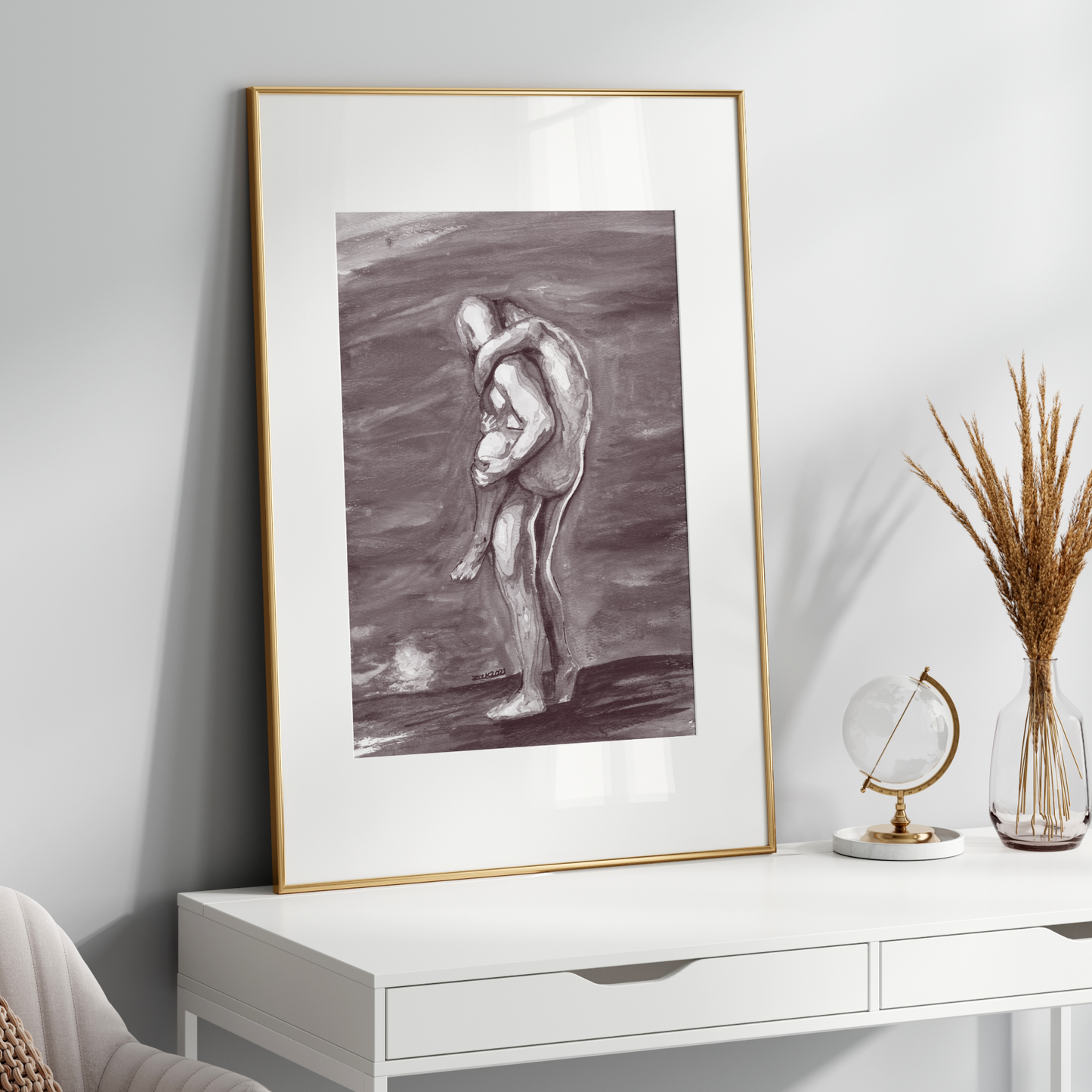 Framed artwork on a white wall above a white console table with decorative items.