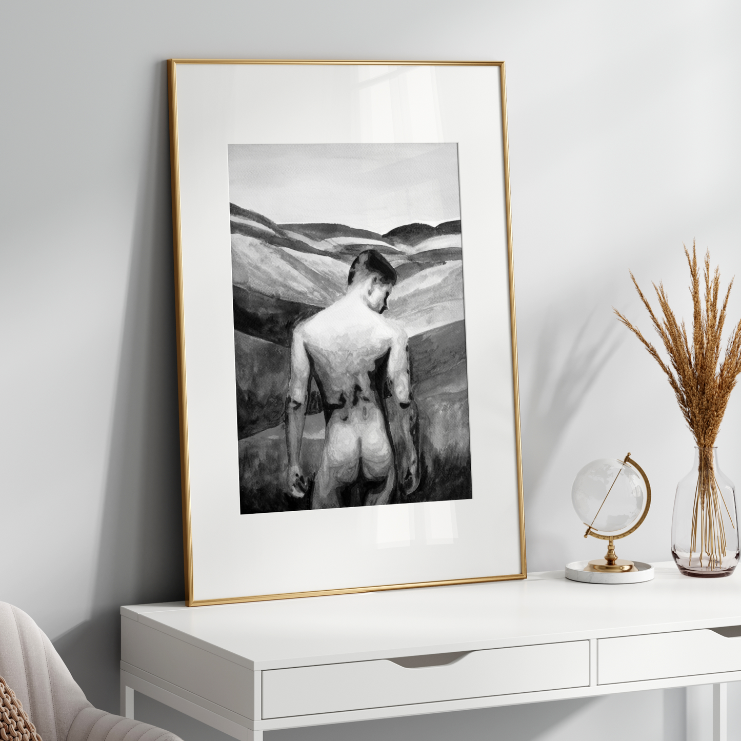 Framed black and white artwork on a white wall above a white console table.